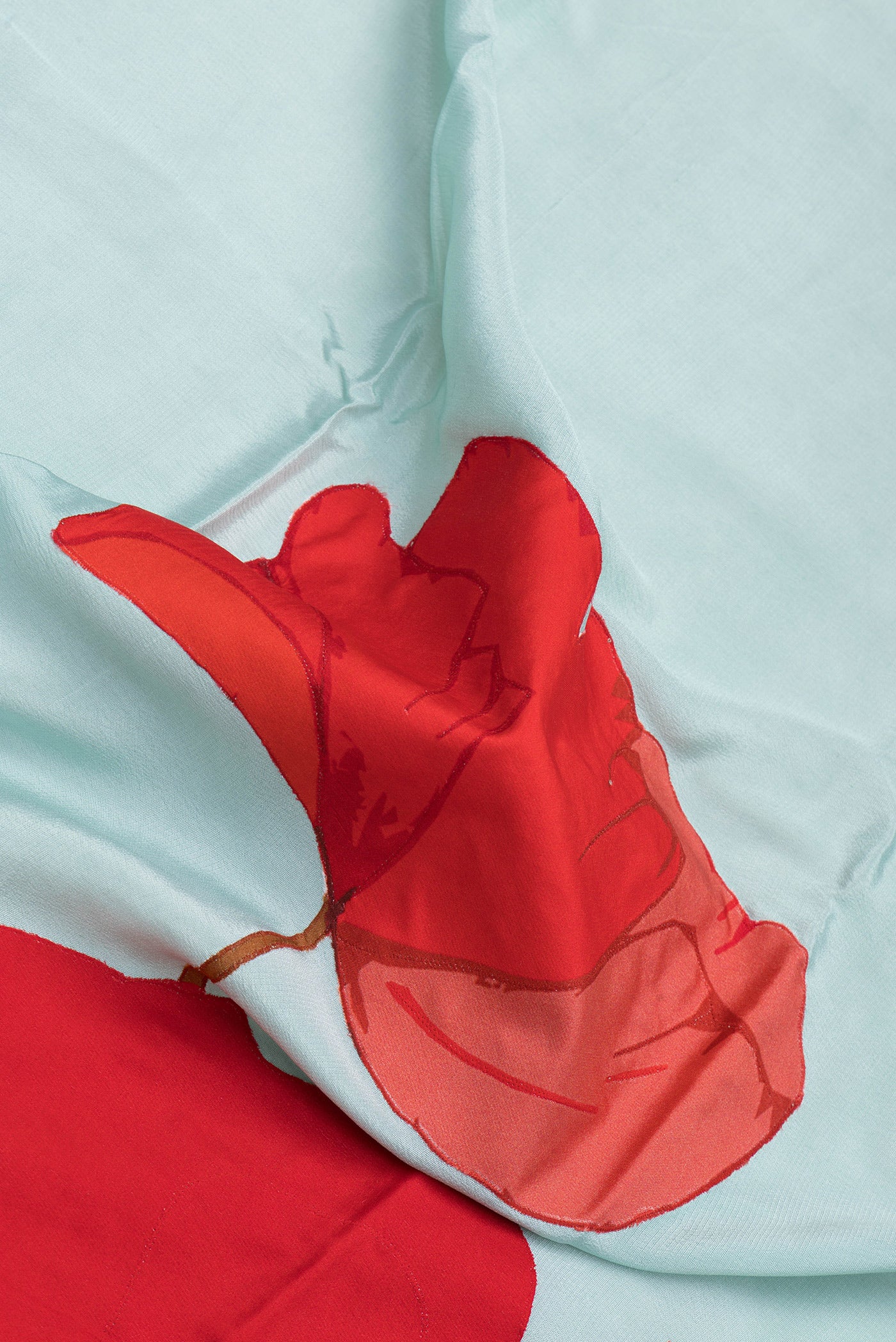 Close up of Sky Blue Crepe Saree with Plain Body and Zari Border.  displaying folds