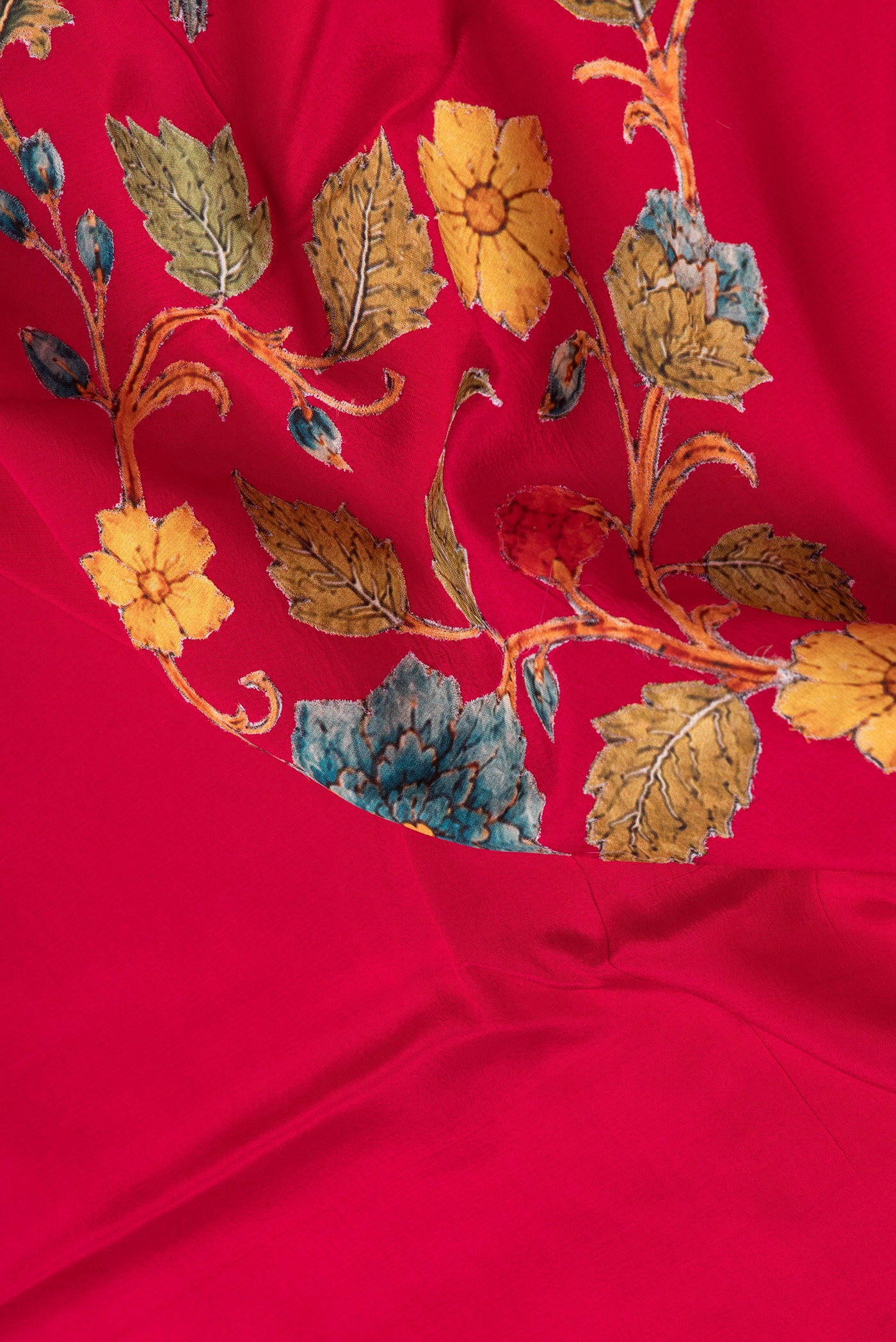 Close up of Dark Pink Crepe Saree with Embroidery on the body and Zari Border.  displaying folds