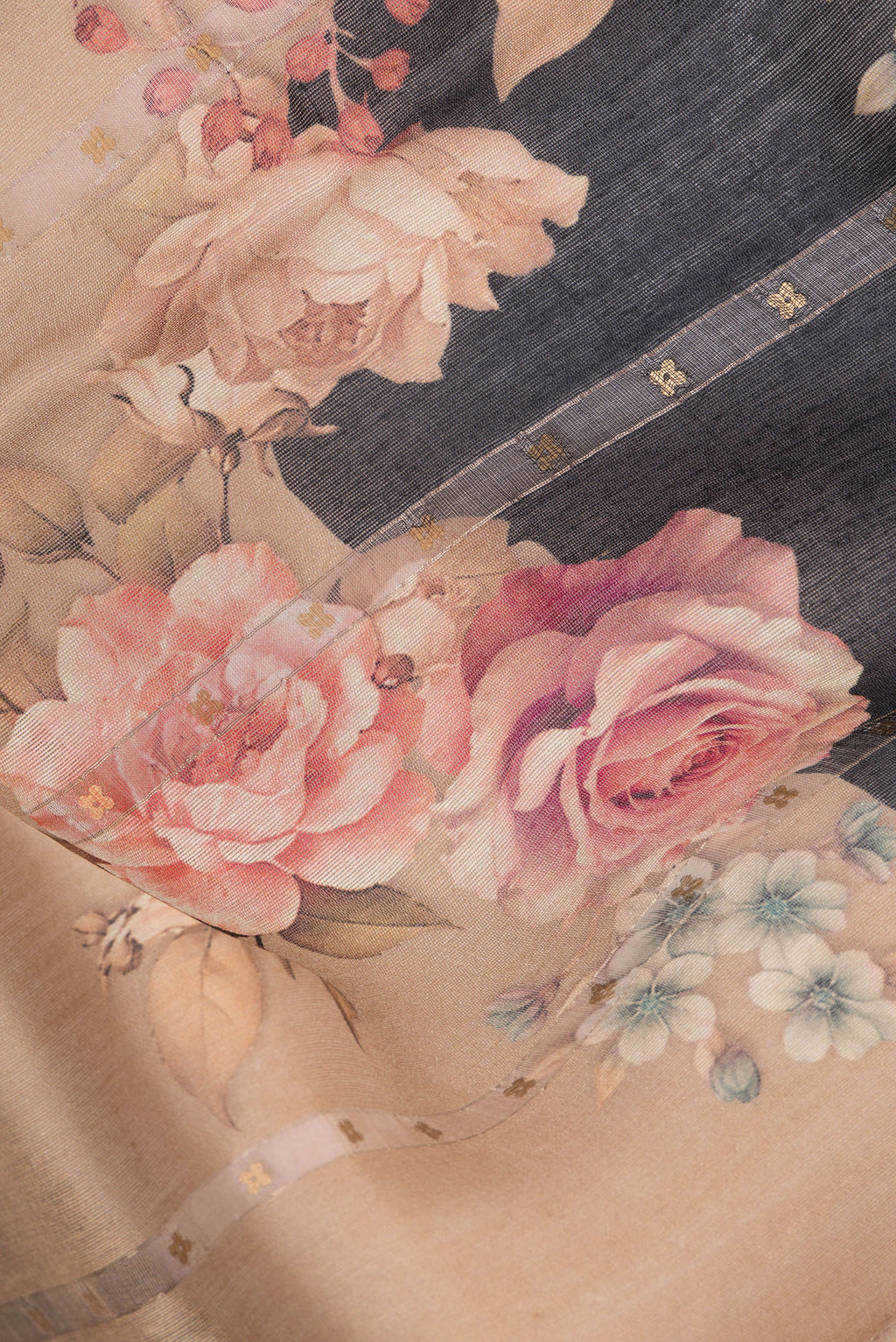 Close up of Brown Tussar Saree with Embroidery on the body and Zari Border.  displaying folds