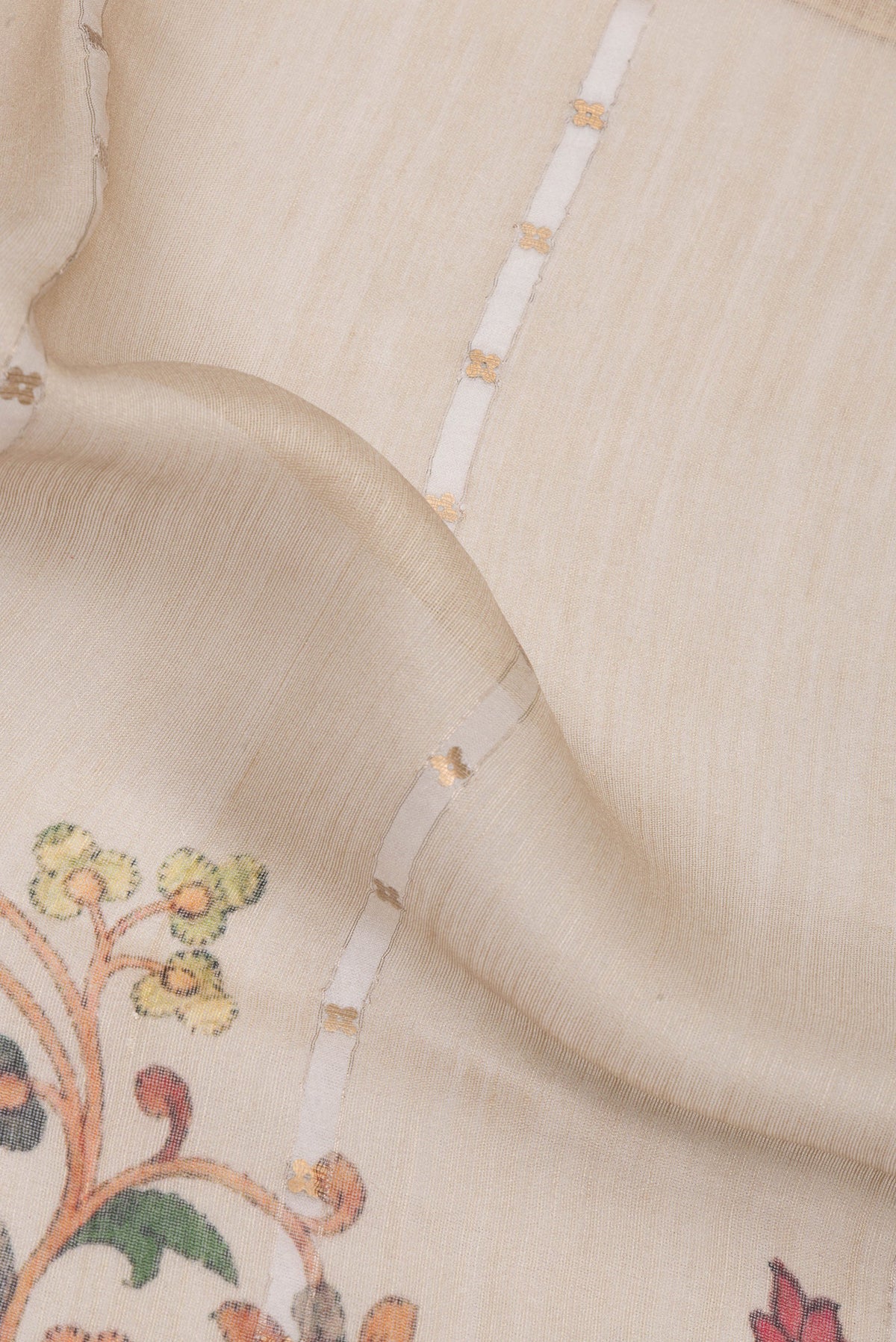 Close up of Pure Silk Beige Dual Tone Tussar Saree with Embroidery on the body and Fancy Border.  displaying folds