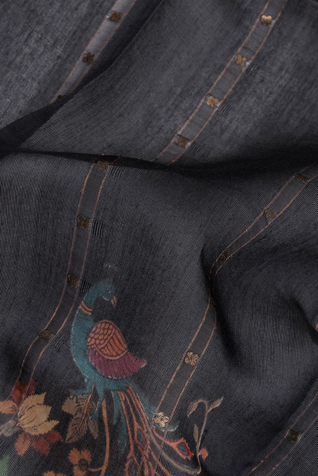 Close up of Pure Silk Black Dual Tone Tussar Saree with Embroidery on the body and Fancy Border.  displaying folds