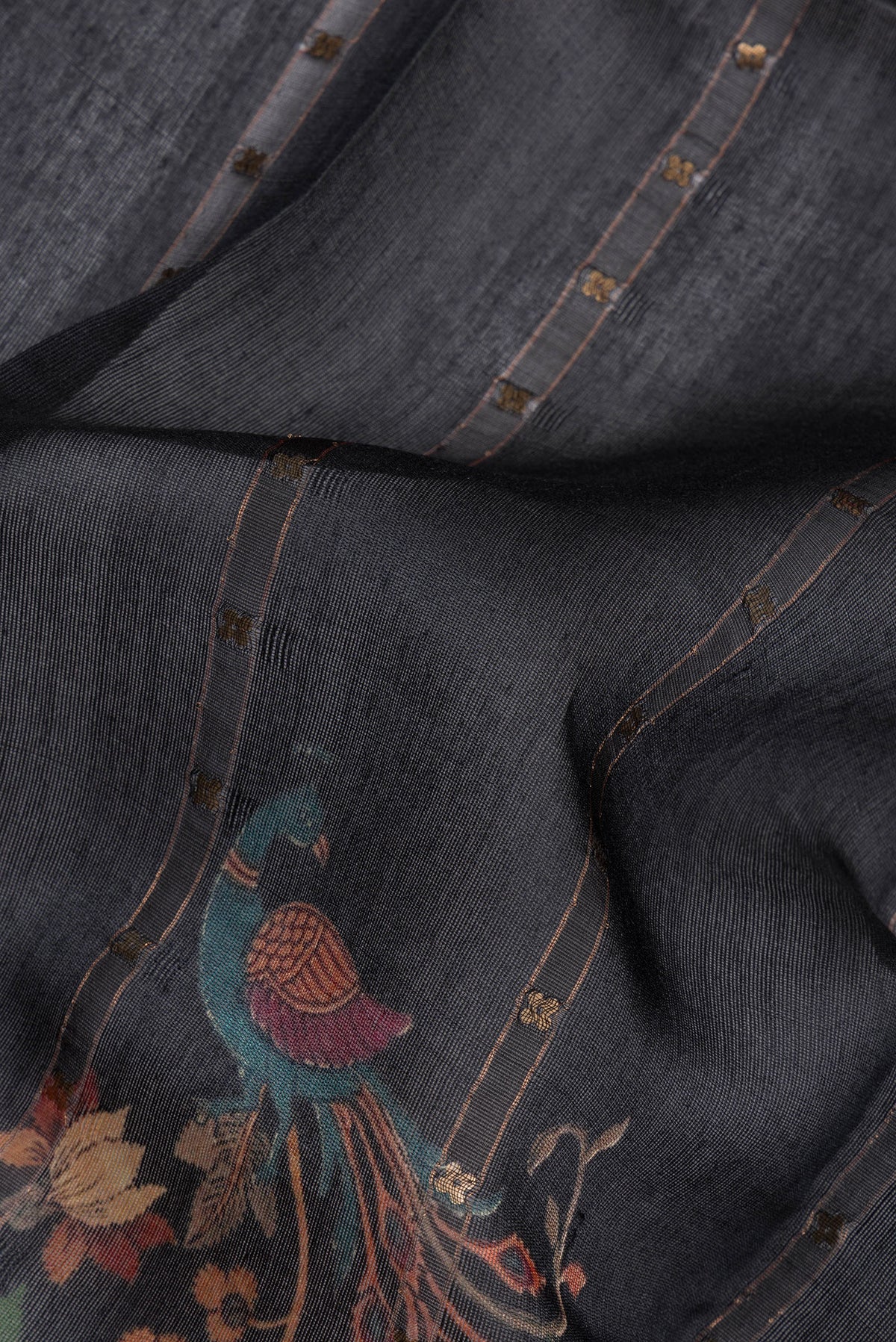 Close up of Pure Silk Black Dual Tone Tussar Saree with Embroidery on the body and Fancy Border.  displaying folds