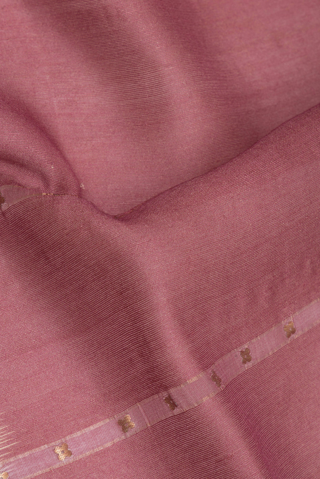 Close up of Pure Silk Coral Tussar Saree with Embroidery on the body and Fancy Border.  displaying folds