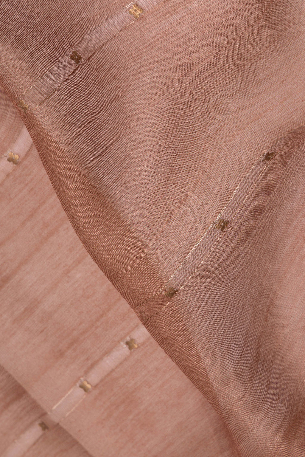 Close up of Brown Tussar Saree with Embroidery on the body and Fancy Border.  displaying folds