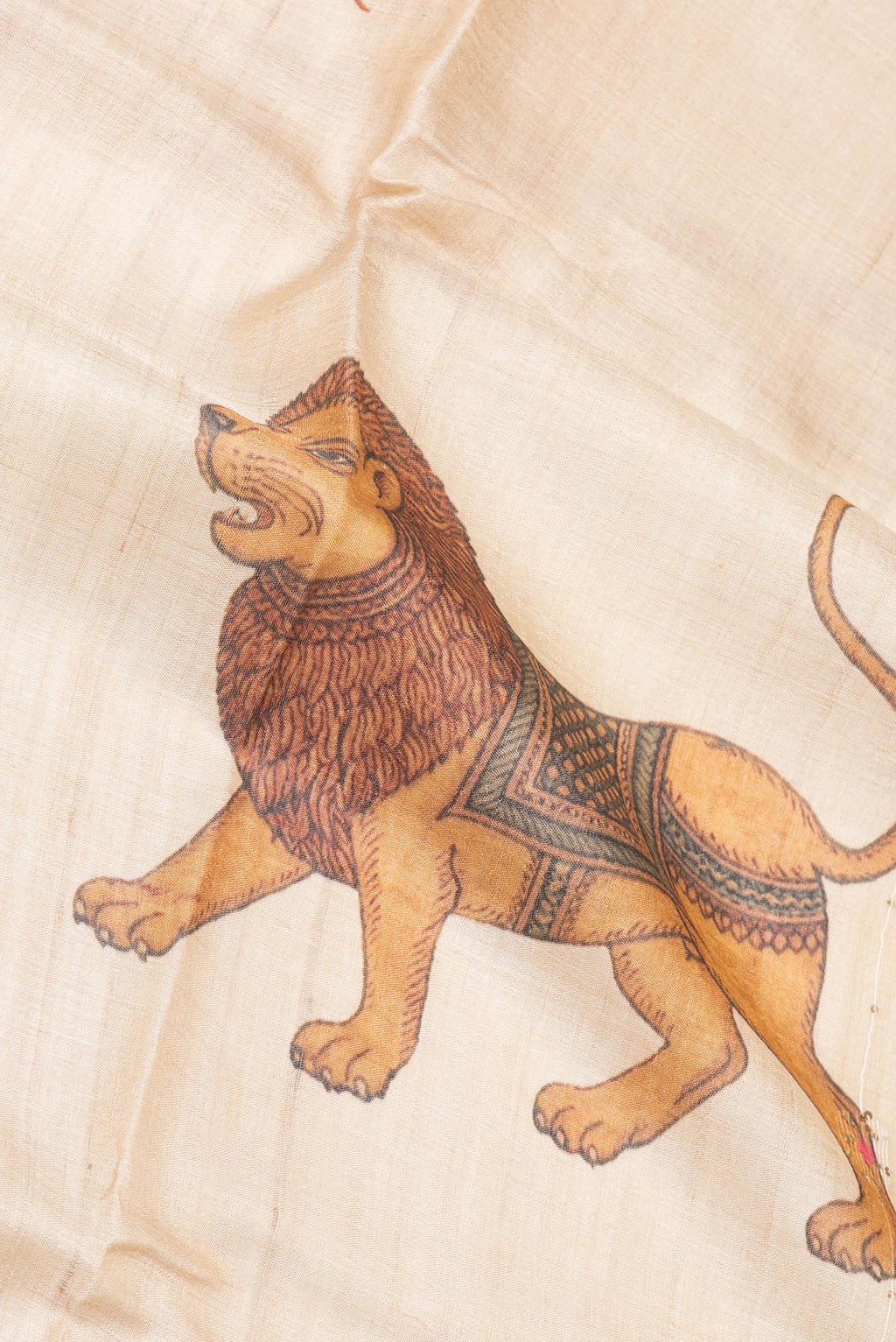 Close up of Pure Silk Beige Dual Tone Tussar Saree with Printed design on the body and Fancy Border.  displaying folds