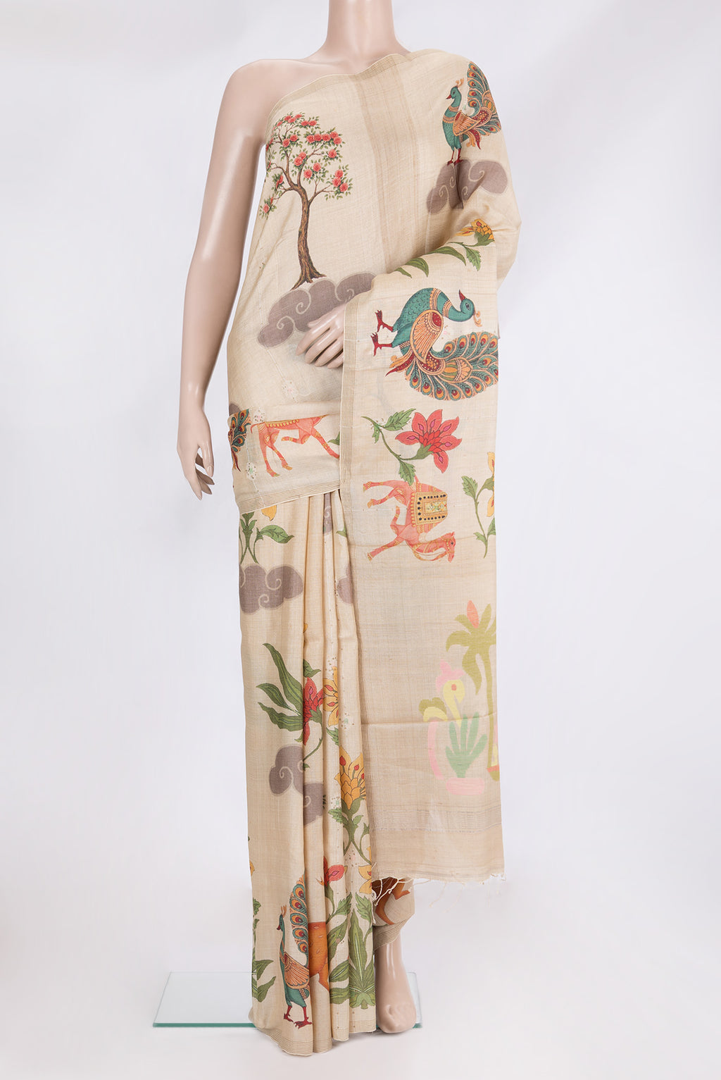 Beige Tussar Saree with Printed design on the body and Zari Border.  displayed on a mannequin