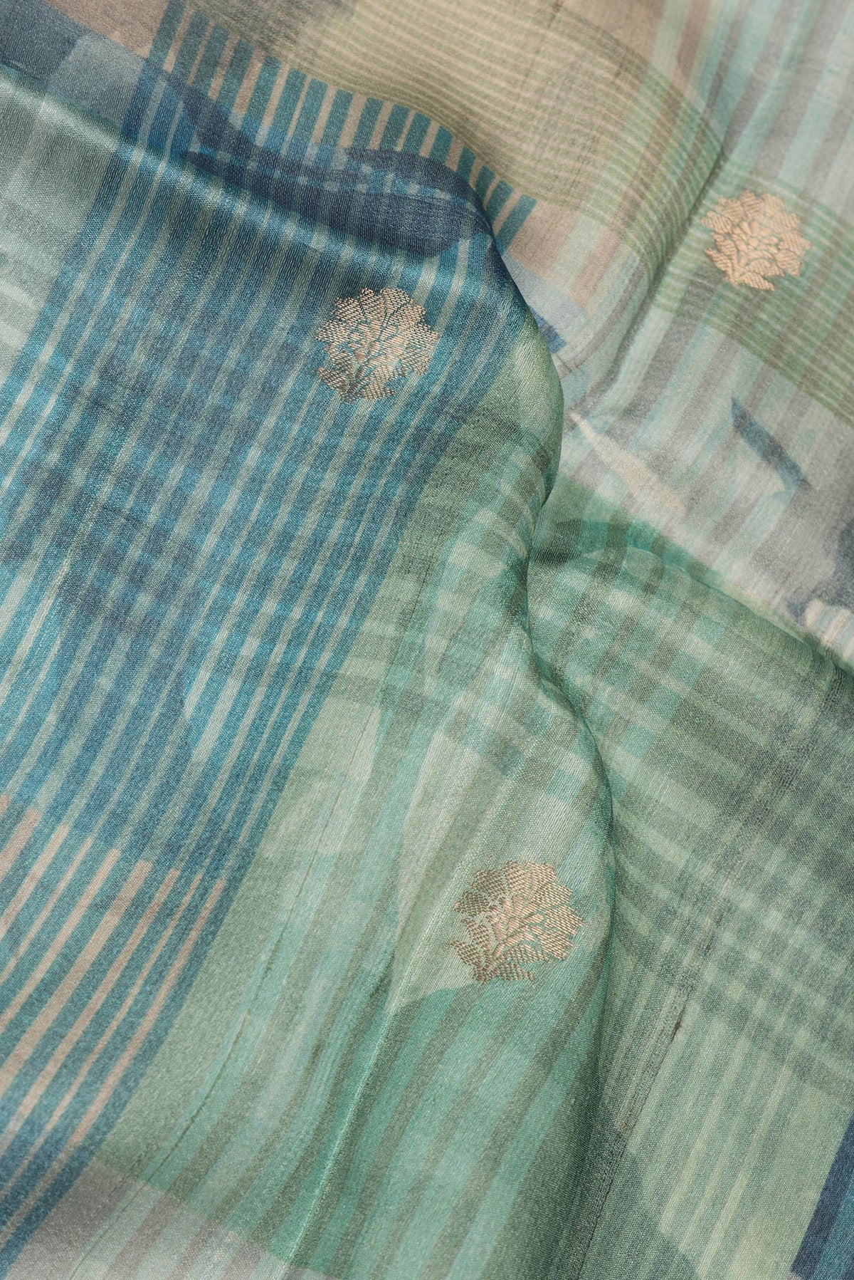 Close up of Pure Silk Multi Color Tussar Saree with Printed design on the body and Fancy Border.  displaying folds