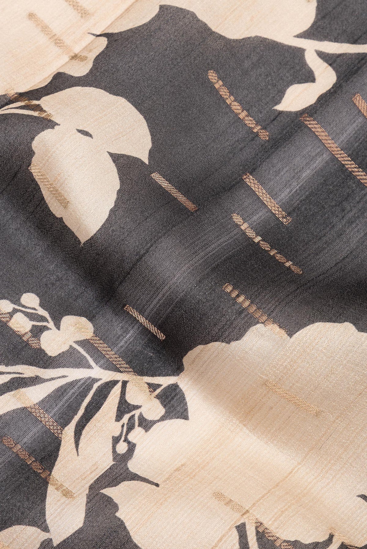 Close up of Black Tussar Saree with Printed design on the body and Fancy Border.  displaying folds