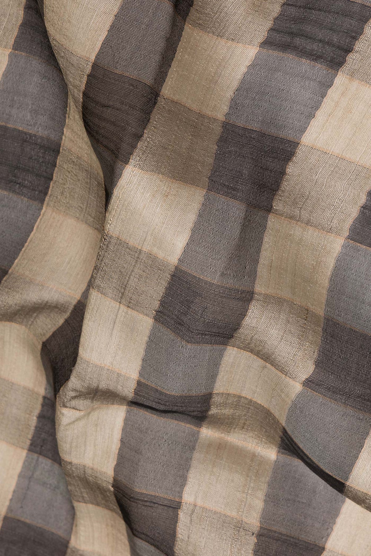 Close up of Multi Color Tussar Saree with Checked design on the body and Zari Border.  displaying folds