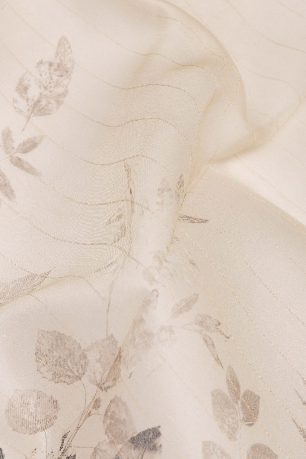 Close up of Beige Organza Saree with Printed design on the body and Plain Border.  displaying folds