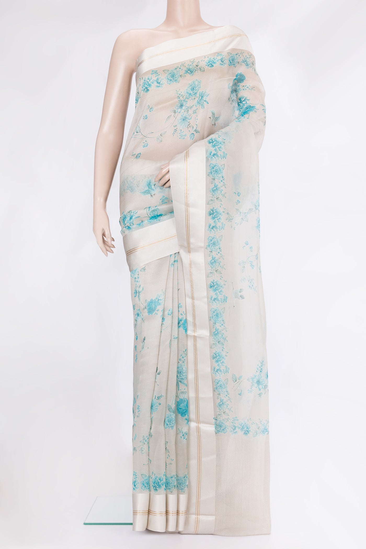 Cream Organza Silk Saree with Floral Print on the body and Satin Border.  displayed on a mannequin