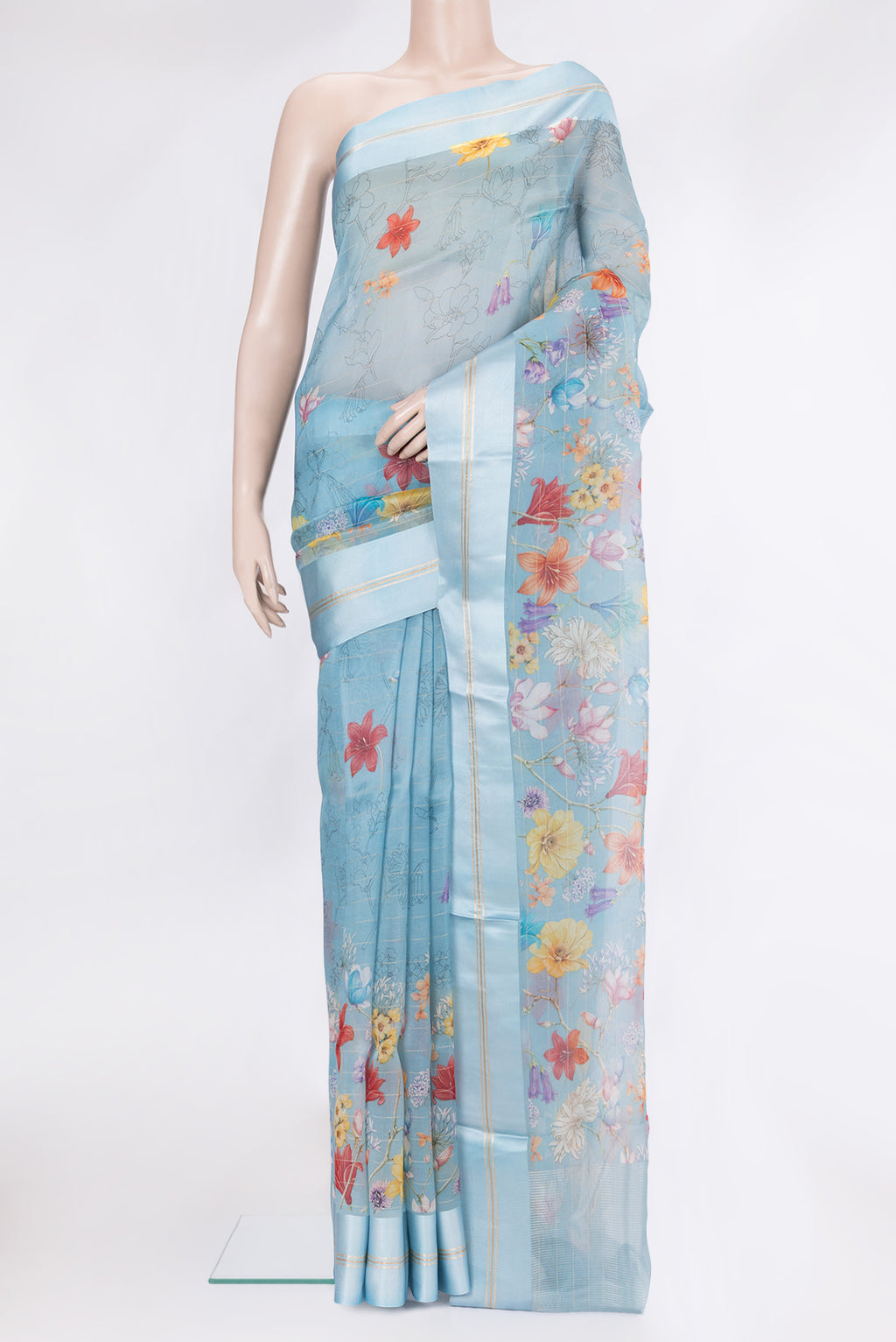 Sky Blue Organza Silk Saree with Floral Print on the body and Satin Border.  displayed on a mannequin