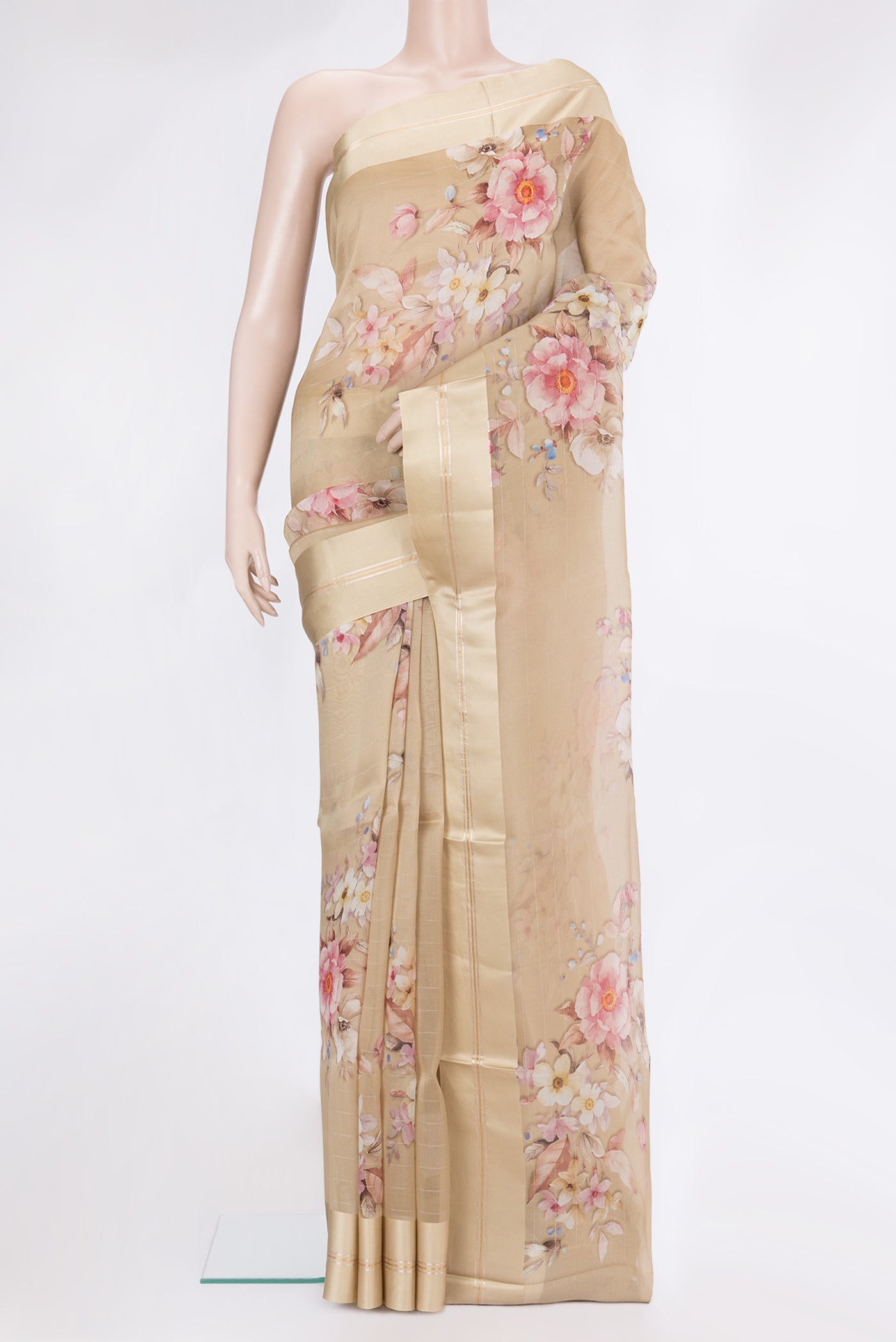 Beige Organza Silk Saree with Floral Print on the body and Satin Border.  displayed on a mannequin