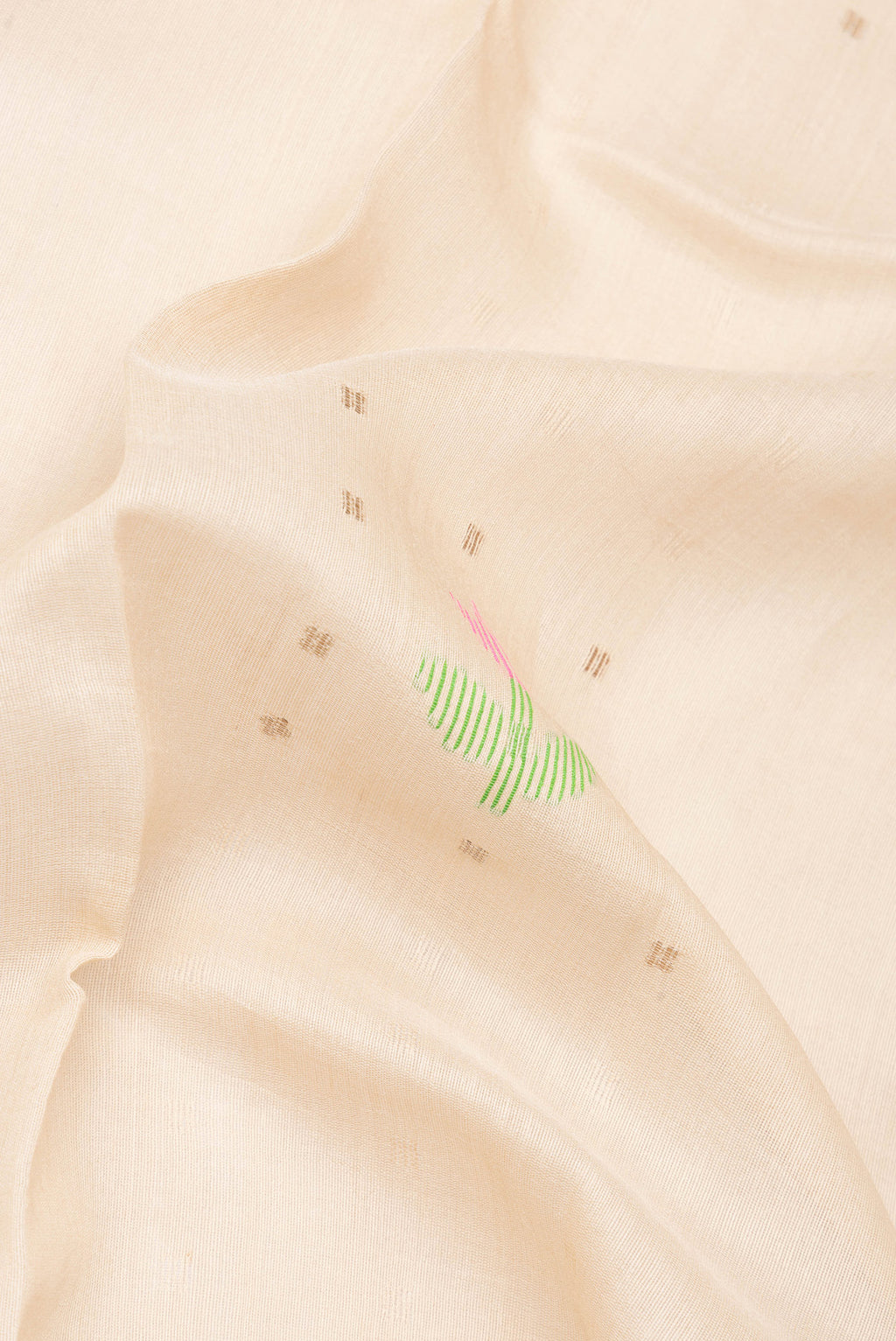 Close up of Pure Silk Beige Tussar Saree with Printed design on the body and Zari Border.  displaying folds