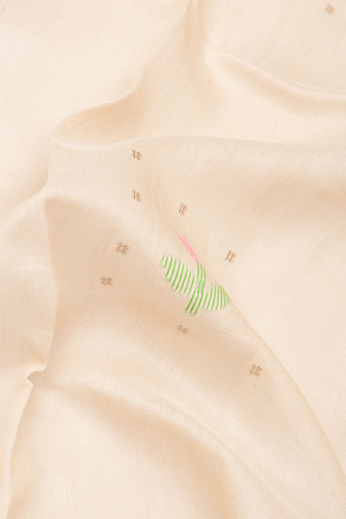 Close up of Pure Silk Beige Tussar Saree with Printed design on the body and Zari Border.  displaying folds