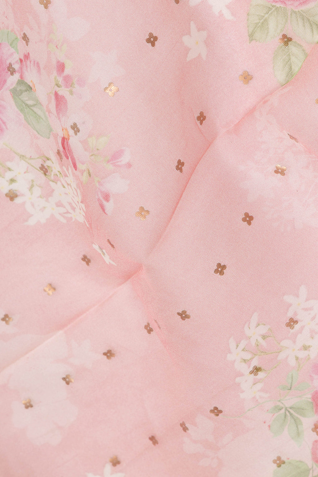 Close up of Pure Silk Pink Tussar Saree with Embroidery on the body and Zari Border.  displaying folds