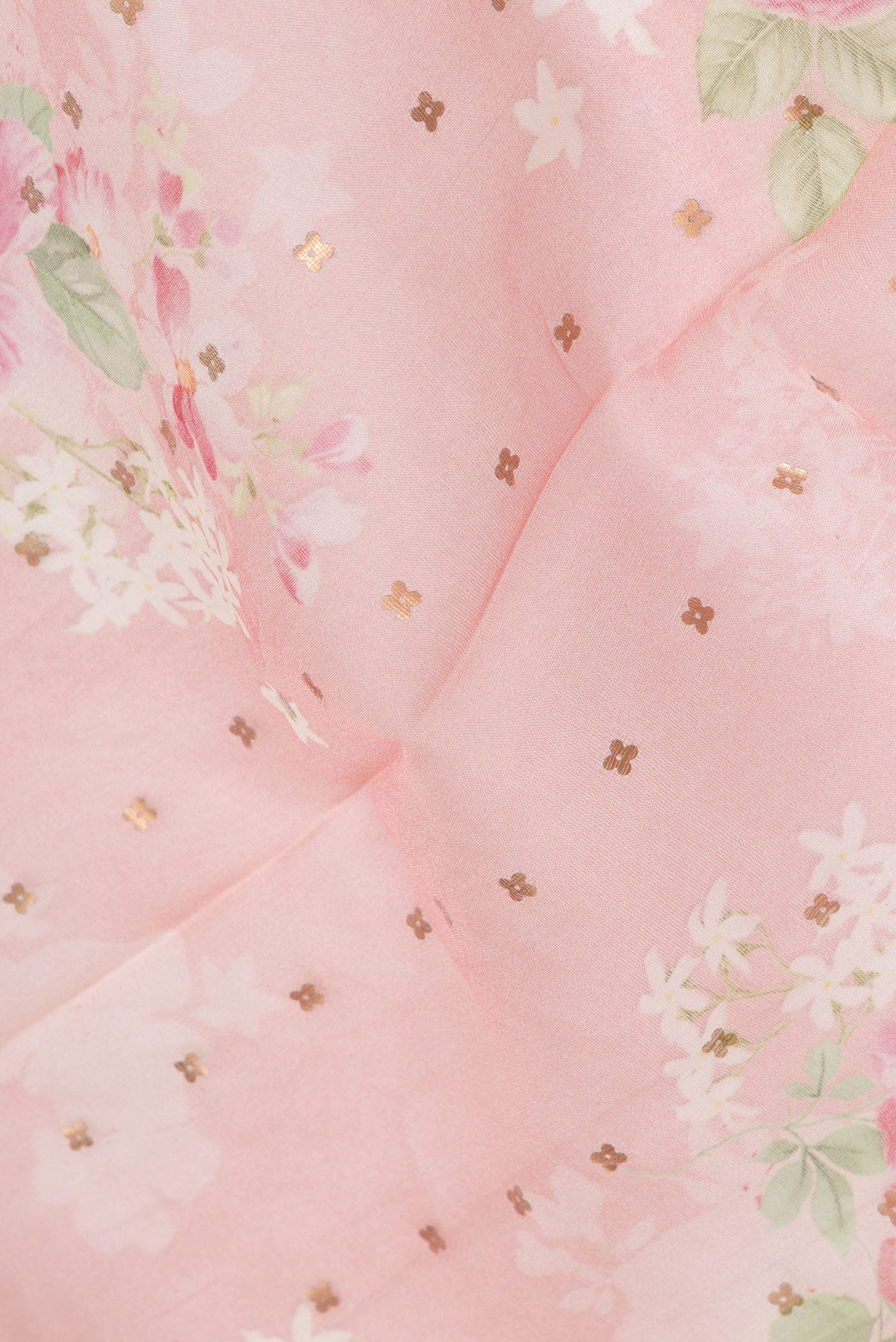 Close up of Pure Silk Pink Tussar Saree with Embroidery on the body and Zari Border.  displaying folds