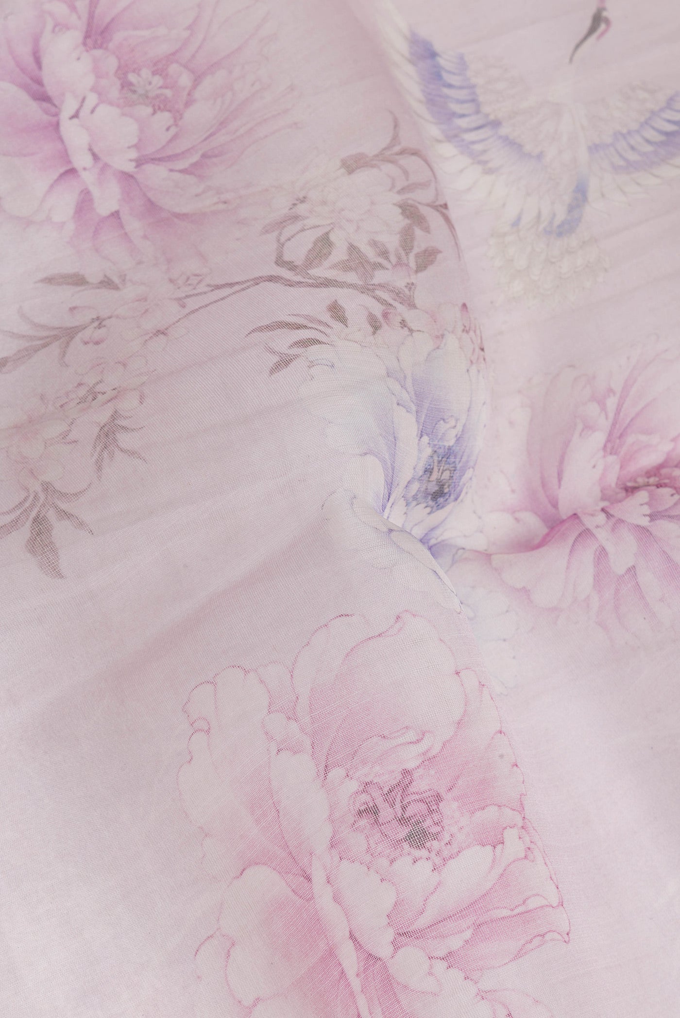 Close up of Lavender Organza Silk Saree with Printed design on the body and Zari Border.  displaying folds