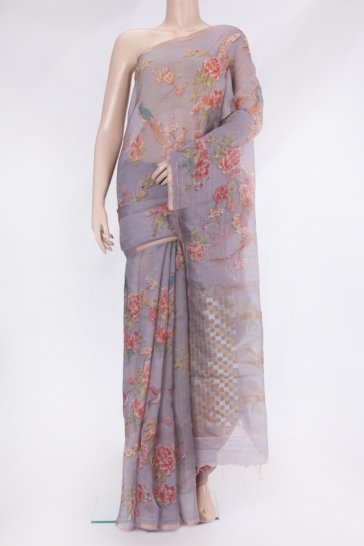 Lavender Organza Silk Saree with Printed design on the body and Zari Border.  displayed on a mannequin