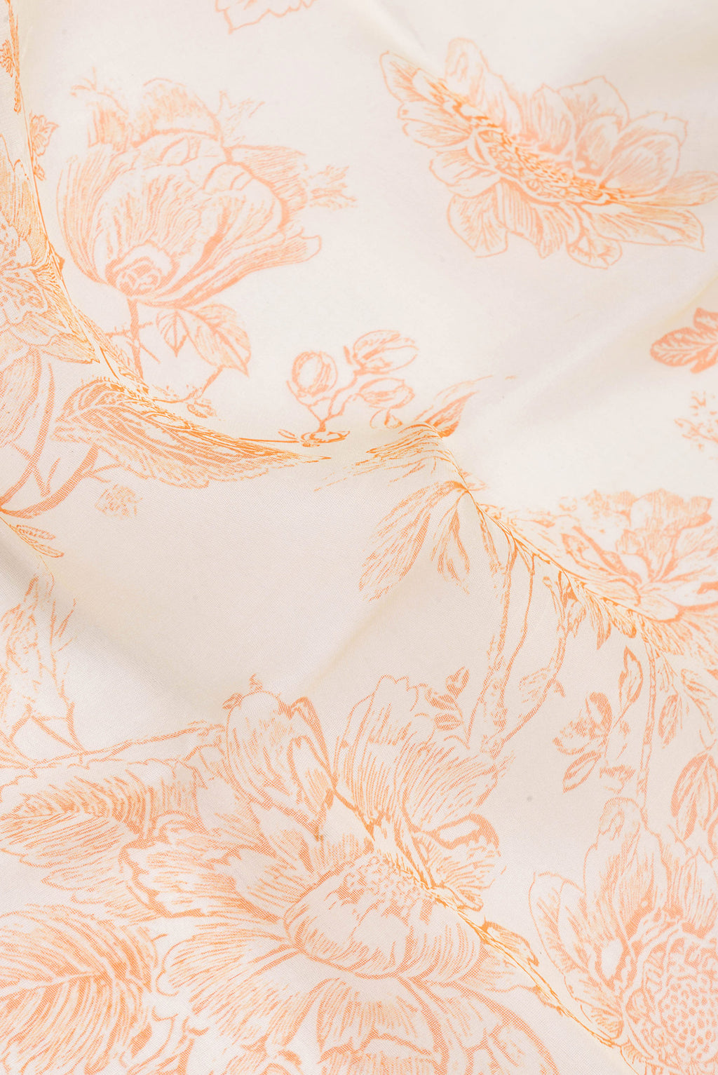 Close up of Beige Organza Silk Saree with Floral Print on the body and Without Border.  displaying folds