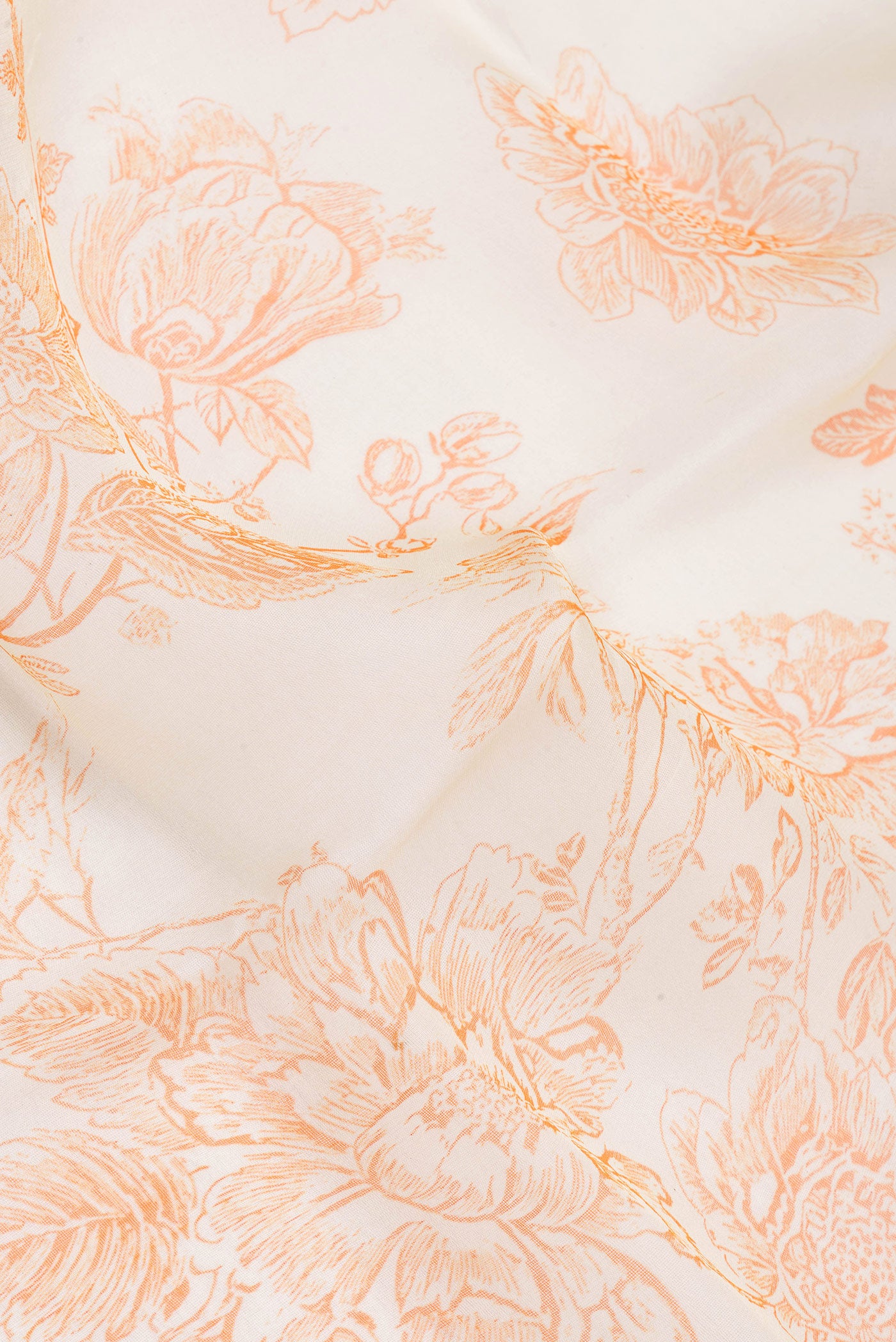 Close up of Beige Organza Silk Saree with Floral Print on the body and Without Border.  displaying folds