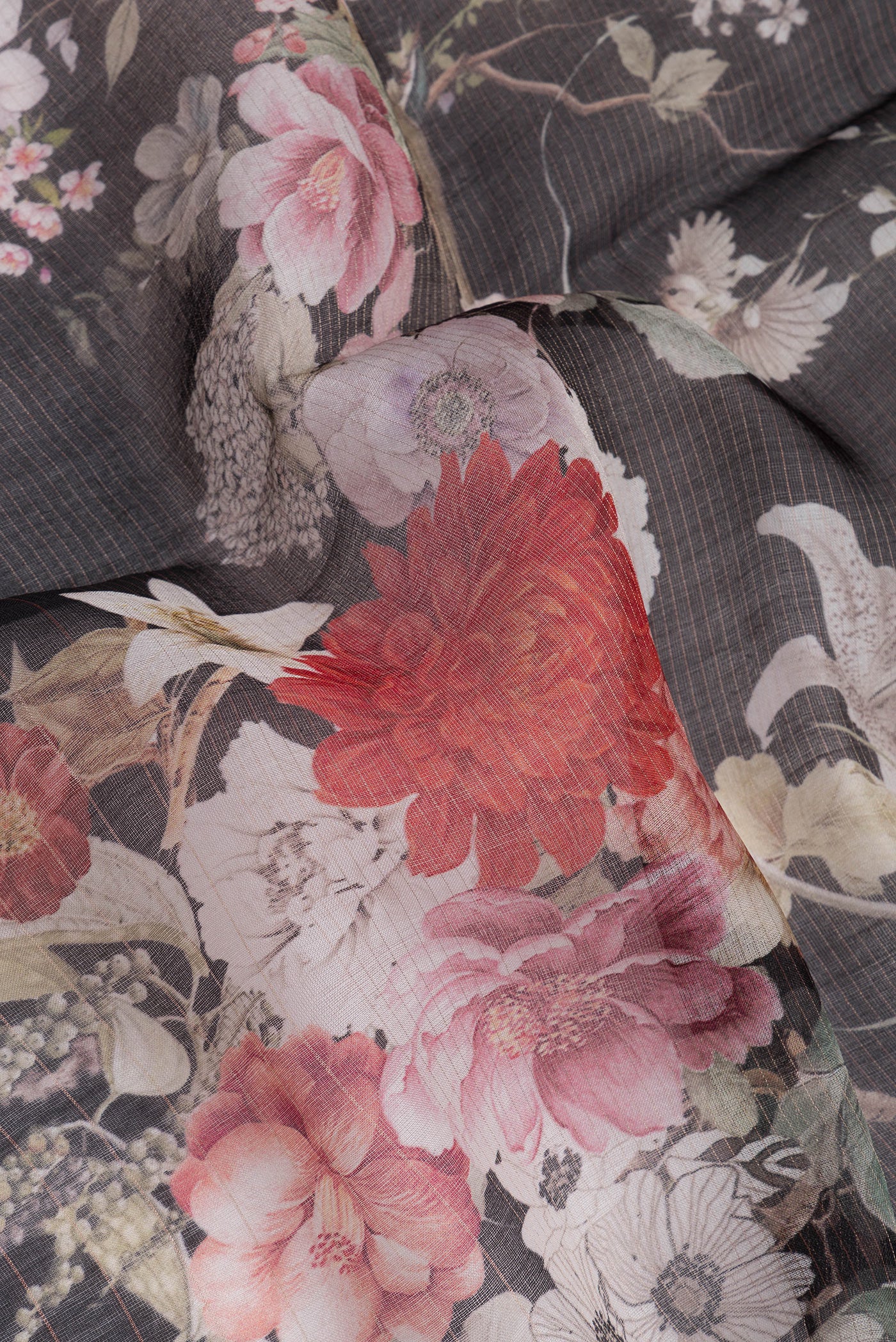 Close up of Black Organza Silk Saree with Floral Print on the body and Zari Border.  displaying folds