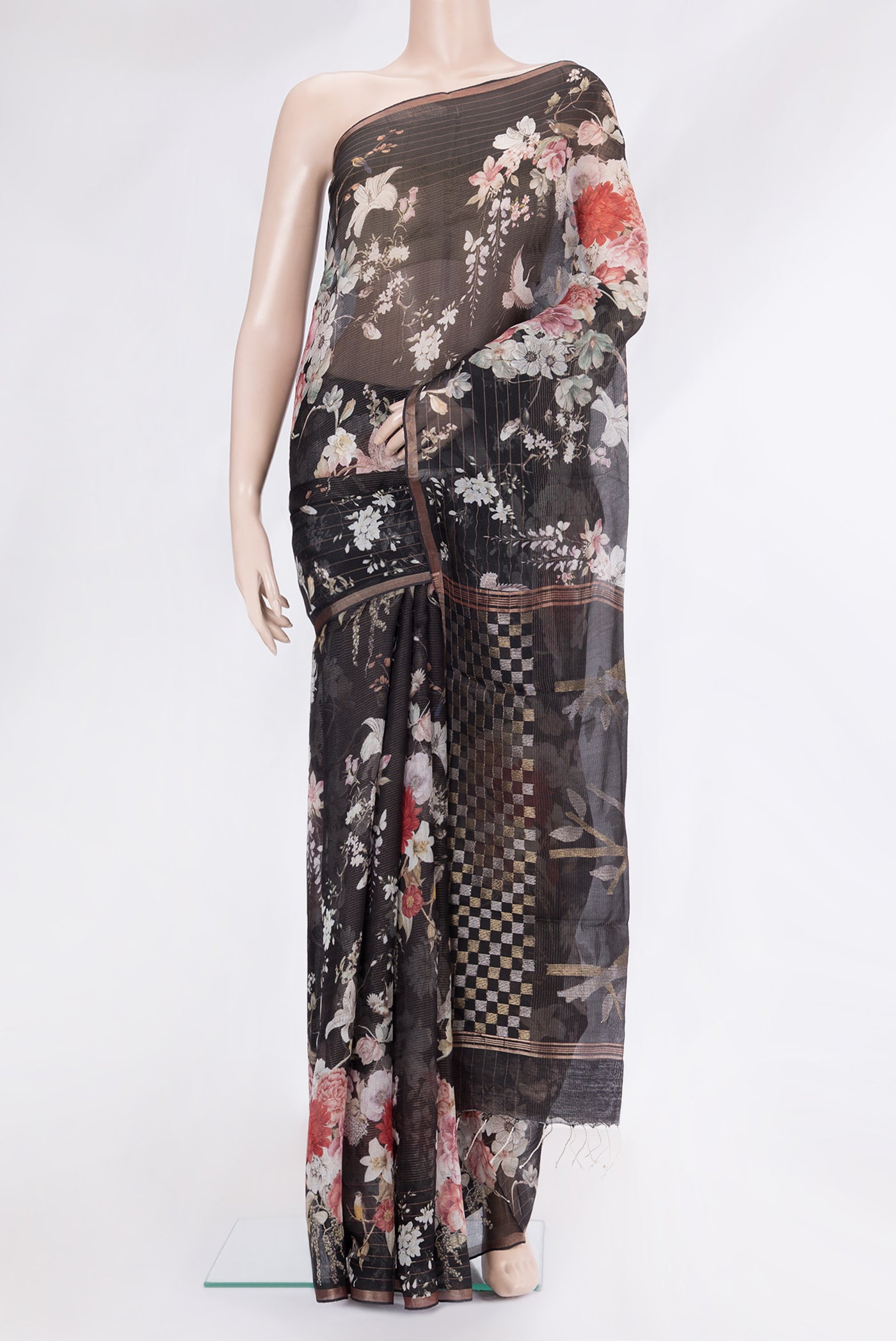 Black Organza Silk Saree with Floral Print on the body and Zari Border.  displayed on a mannequin