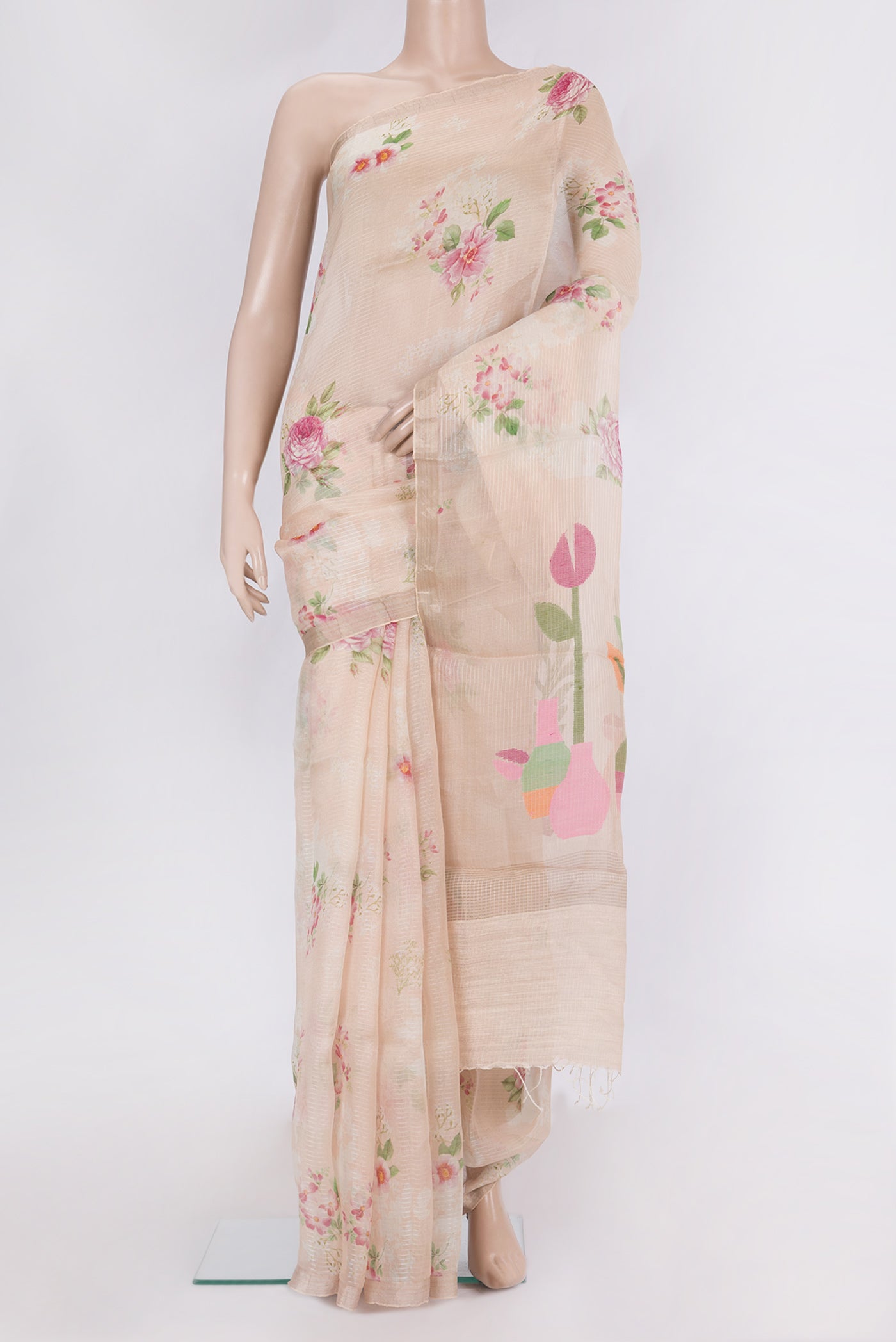 Pure Silk Golden Peach Tussar Saree with Floral Print on the body and Zari Border.  displayed on a mannequin