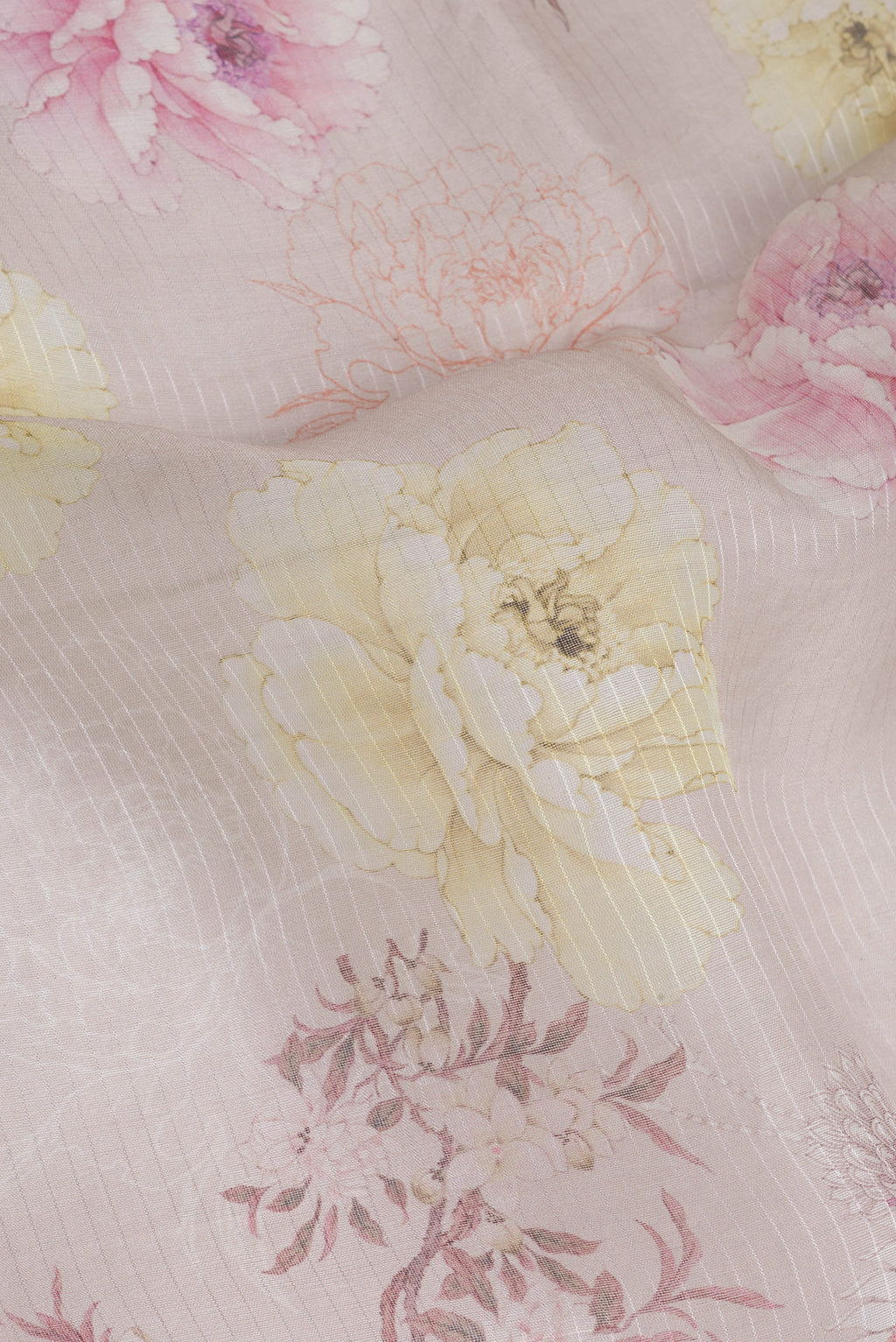 Close up of Beige Organza Silk Saree with Floral Print on the body and Zari Border.  displaying folds