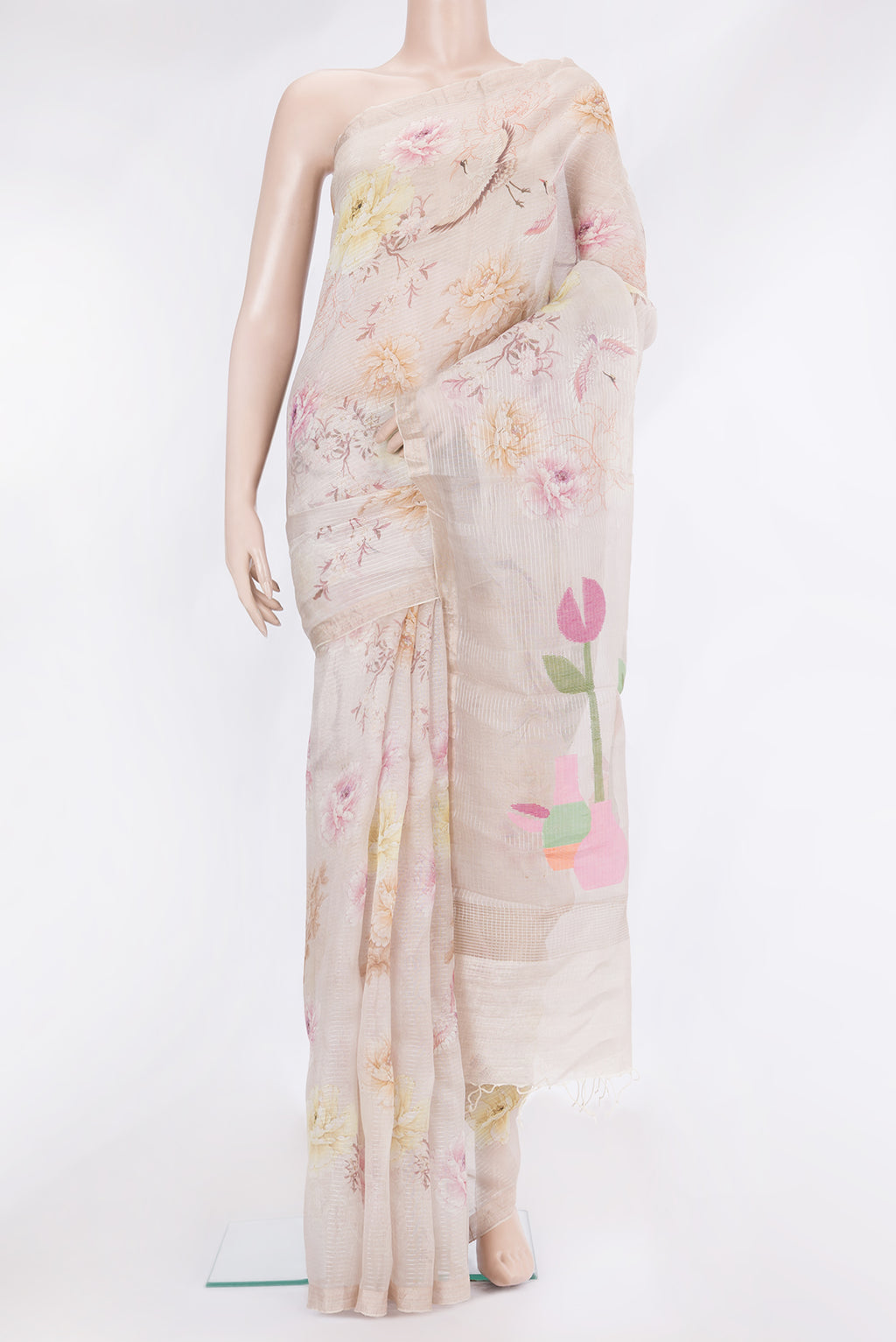 Beige Organza Silk Saree with Floral Print on the body and Zari Border.  displayed on a mannequin