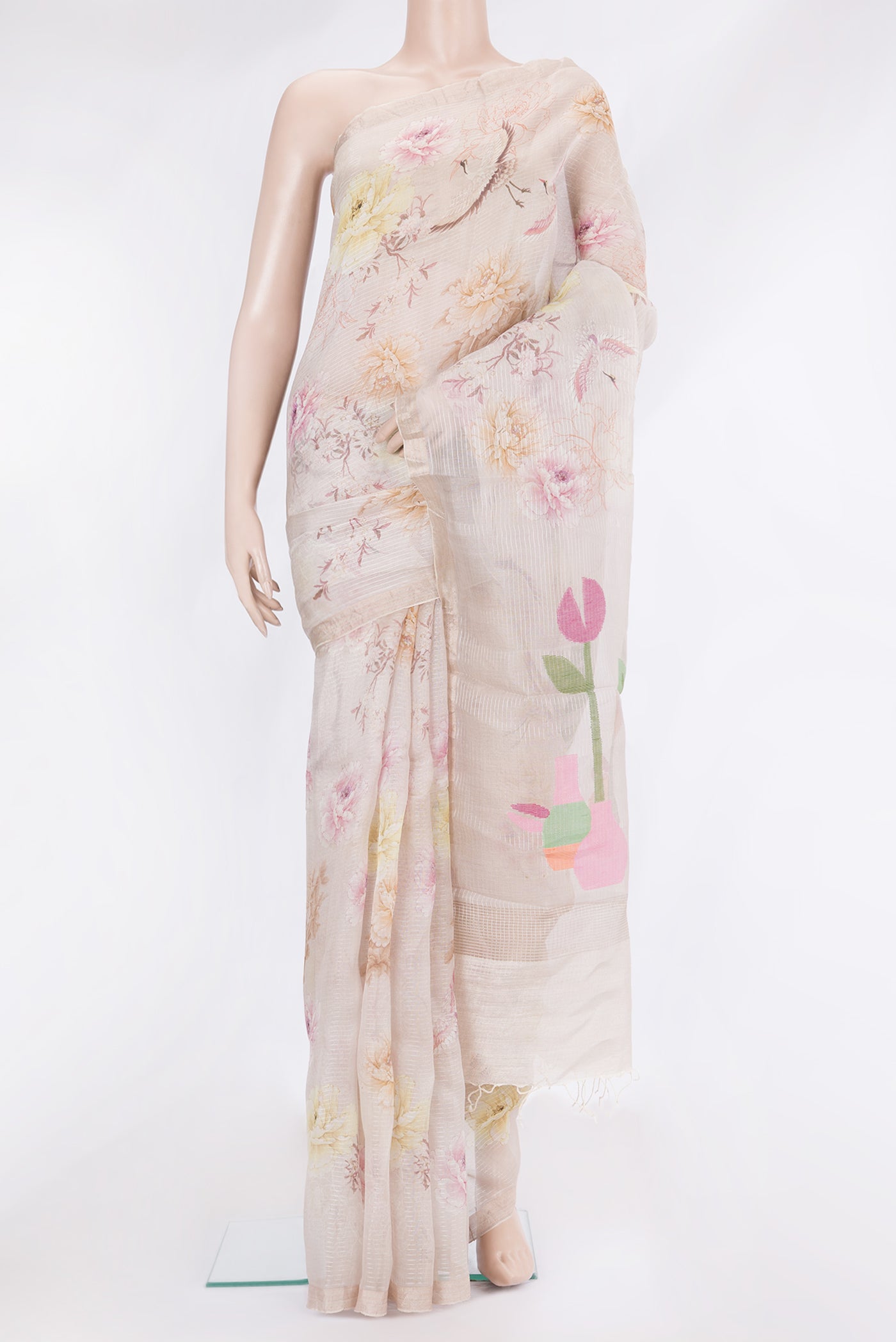 Beige Organza Silk Saree with Floral Print on the body and Zari Border.  displayed on a mannequin
