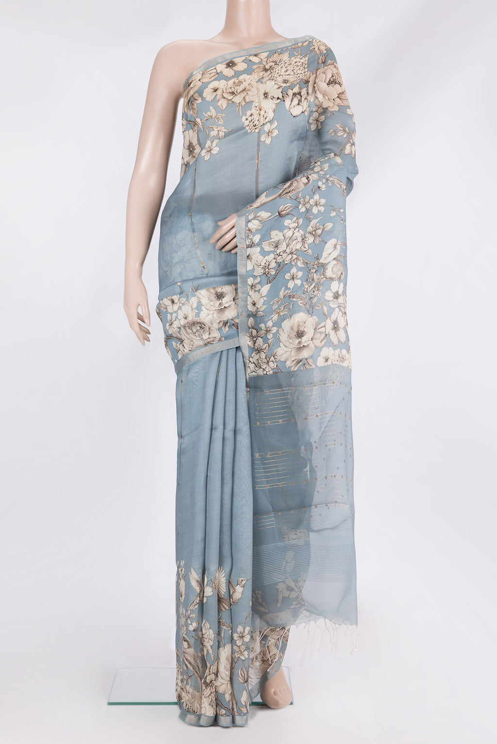Pure Silk Light Blue Tussar Saree with Floral Print on the body and Zari Border.  displayed on a mannequin
