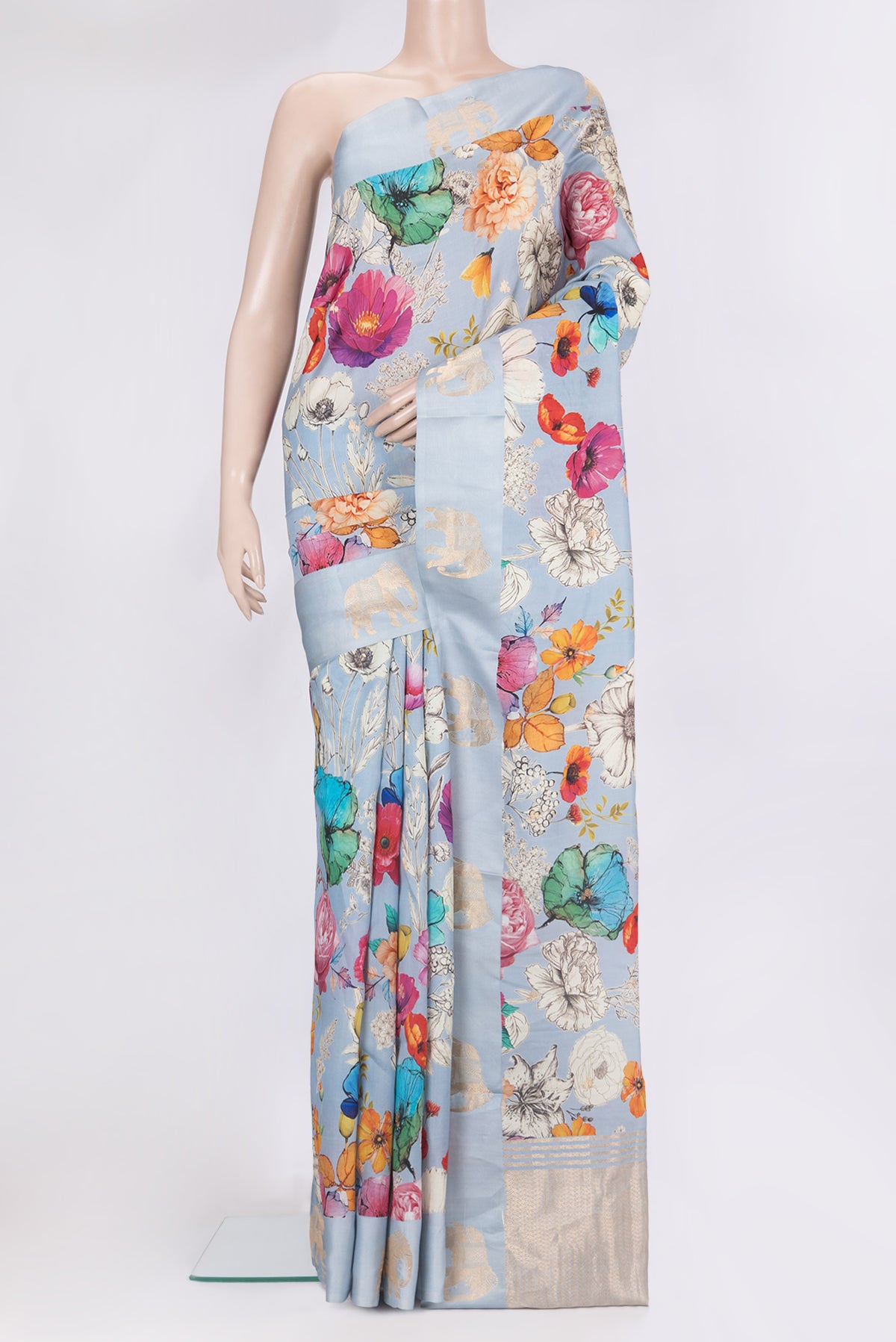Pure Silk Sky Blue Tussar Saree with Zari Butta on the body and Fancy Border.  displayed on a mannequin