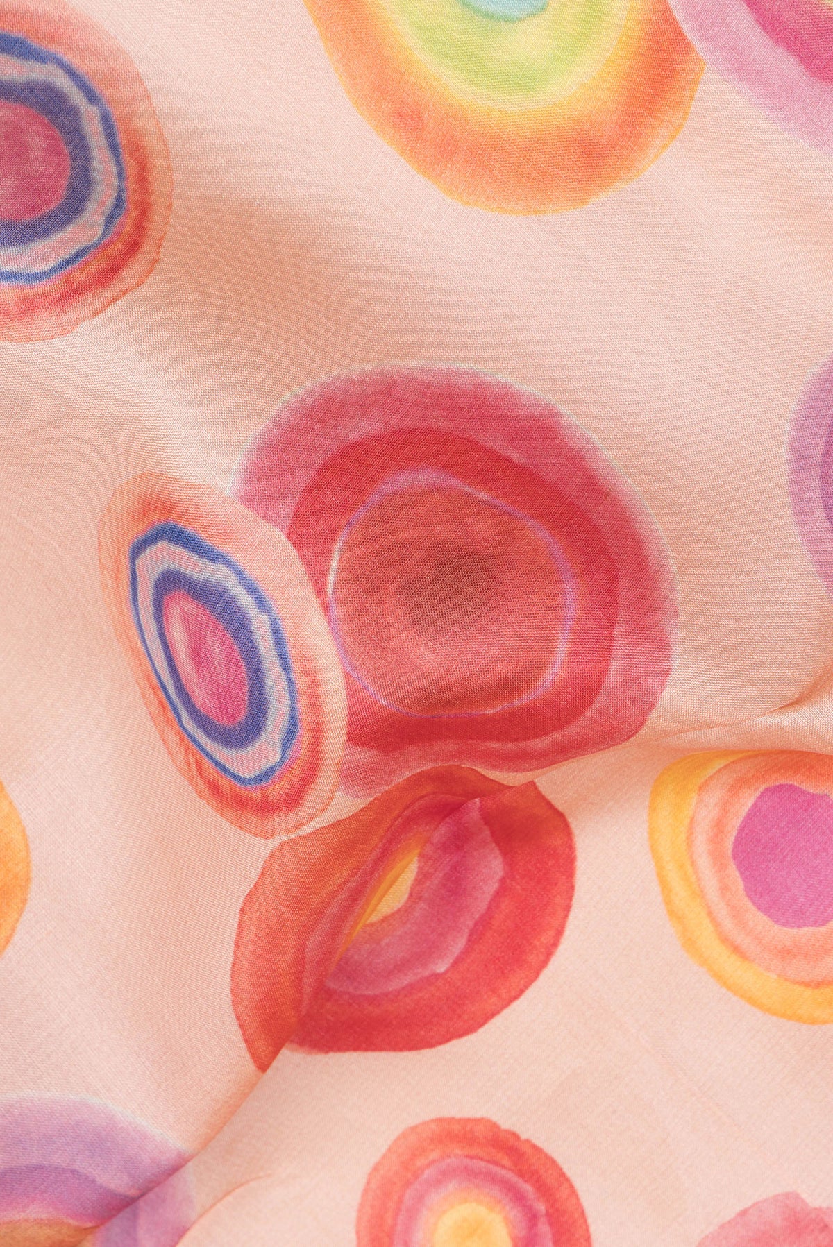 Close up of Golden Peach Tussar Saree with Printed design on the body and Fancy Border.  displaying folds