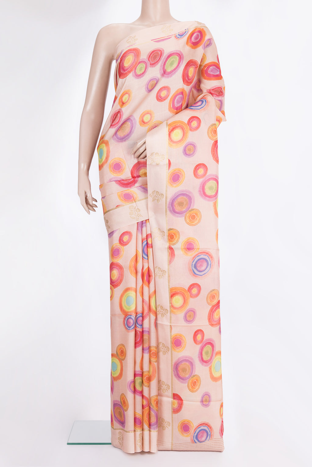 Golden Peach Tussar Saree with Printed design on the body and Fancy Border.  displayed on a mannequin