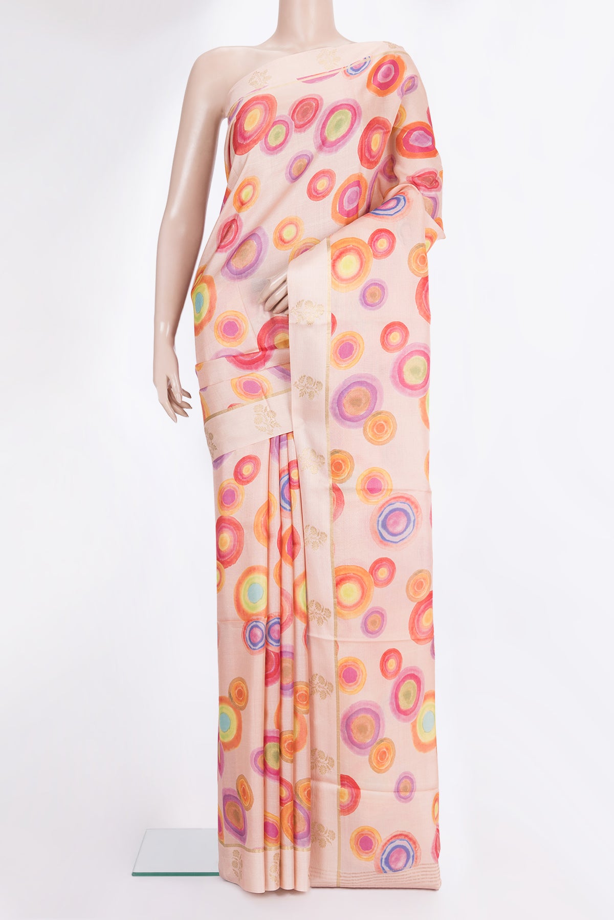 Golden Peach Tussar Saree with Printed design on the body and Fancy Border.  displayed on a mannequin