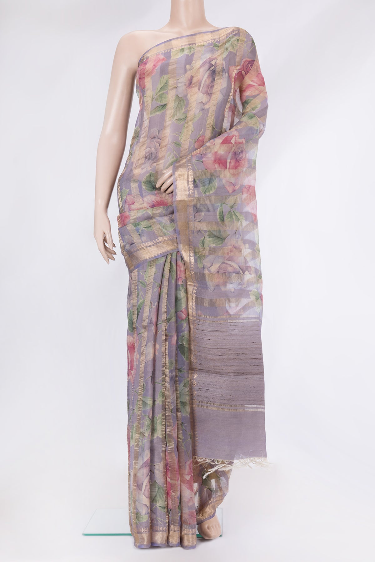 Lavender Organza Silk Saree with Stripes on the body and Zari Border.  displayed on a mannequin