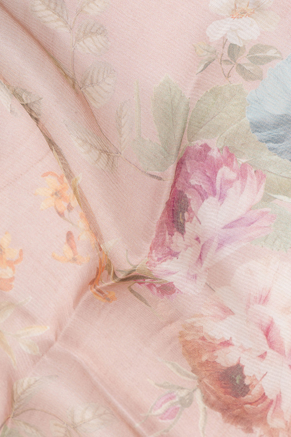 Close up of Rose Gold Dual Tone Tussar Saree with Floral Print on the body and Sequin Border.  displaying folds