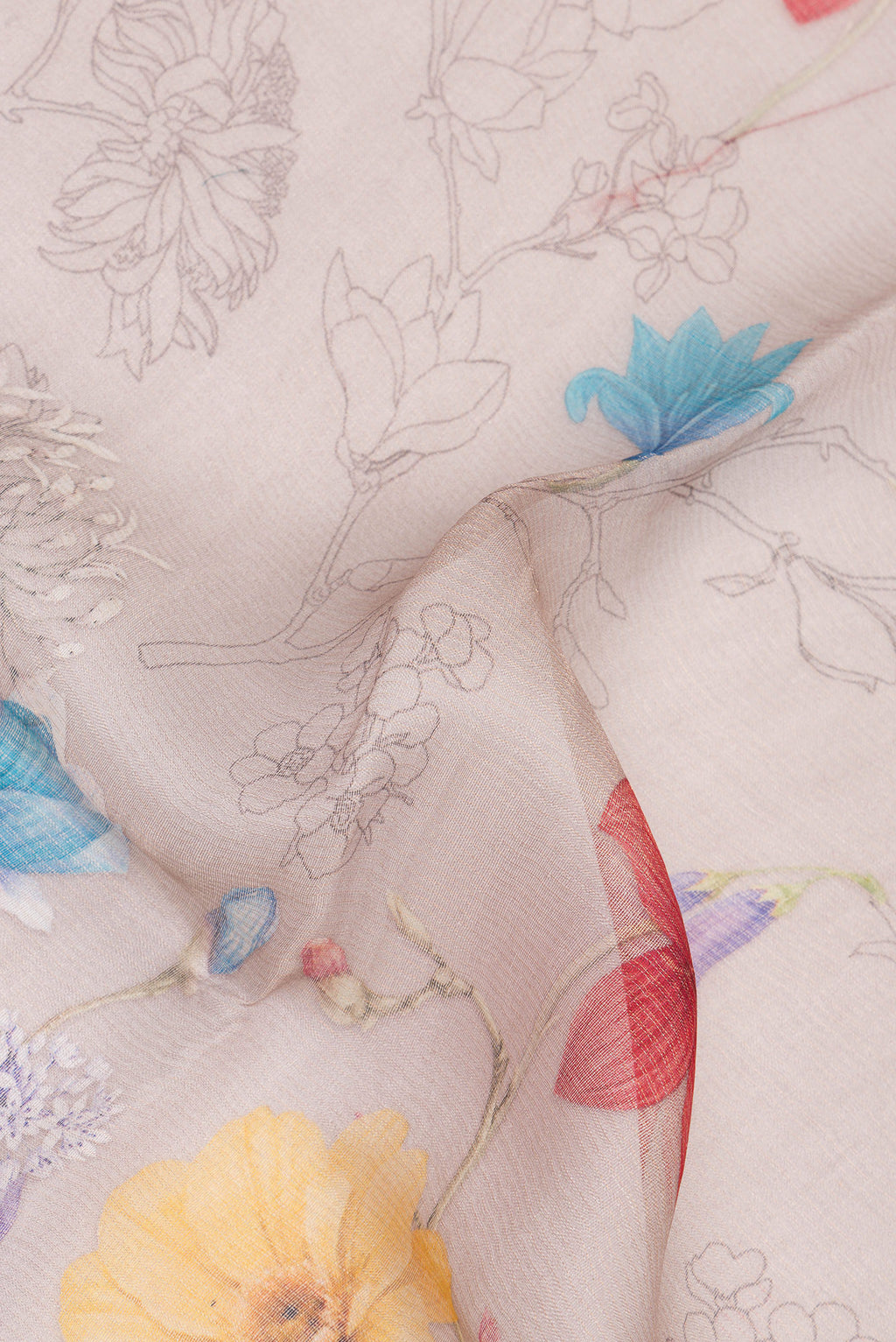 Close up of Beige Tussar Saree with Floral Print on the body and Sequin Border.  displaying folds