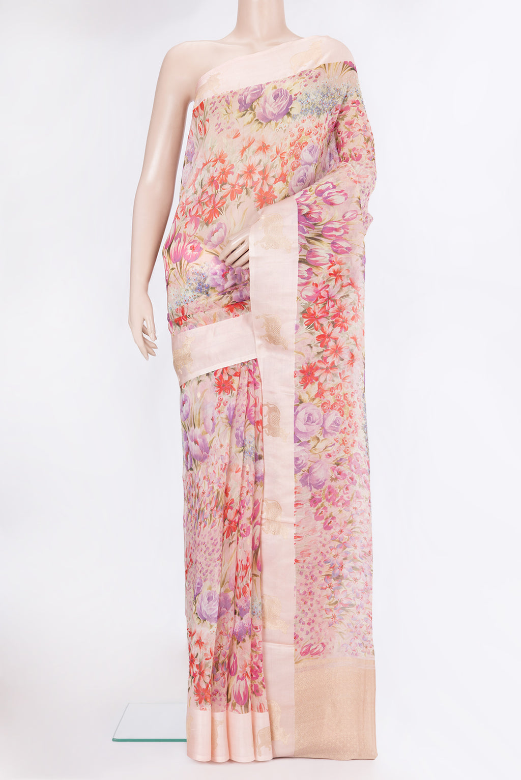 Golden Peach Organza Silk Saree with Floral Print on the body and Fancy Border.  displayed on a mannequin