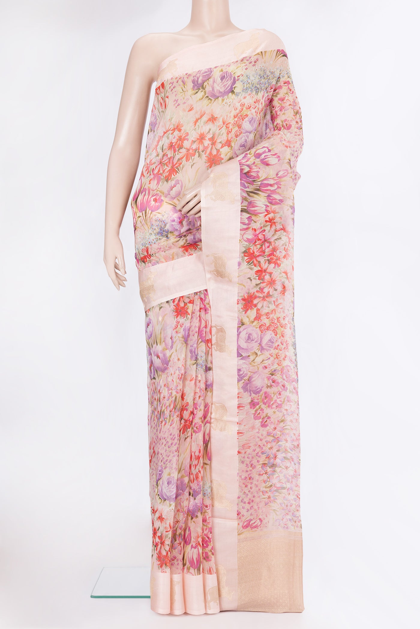 Golden Peach Organza Silk Saree with Floral Print on the body and Fancy Border.  displayed on a mannequin