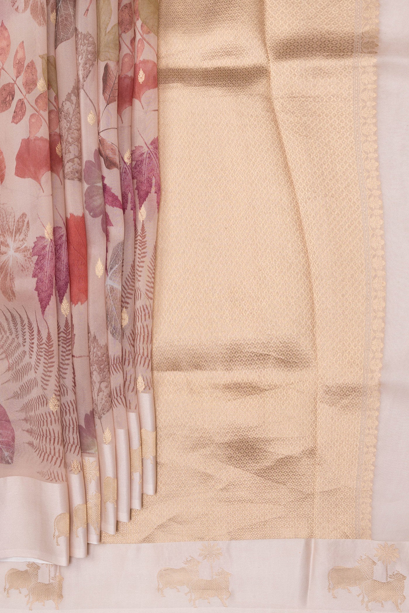 Pleats and pallu of Rose Gold Organza Silk Saree with Floral Print on the body and Fancy Border. 