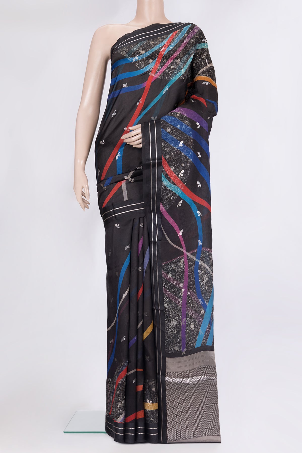 Pure Silk Black Tussar Saree with Zari Butta on the body and Fancy Border.  displayed on a mannequin