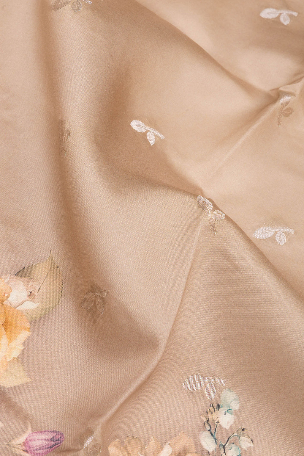 Close up of Pure Silk Brown Tussar Saree with Floral Print on the body and Zari Border.  displaying folds
