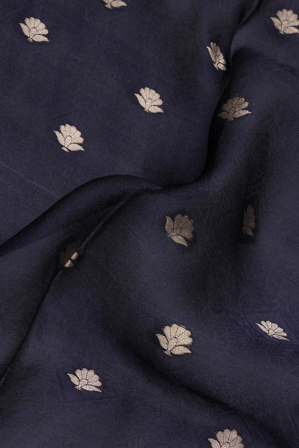 Close up of Navy Blue Organza Silk Saree with Jacquard With Zari Butta on the body and Fancy Border.  displaying folds