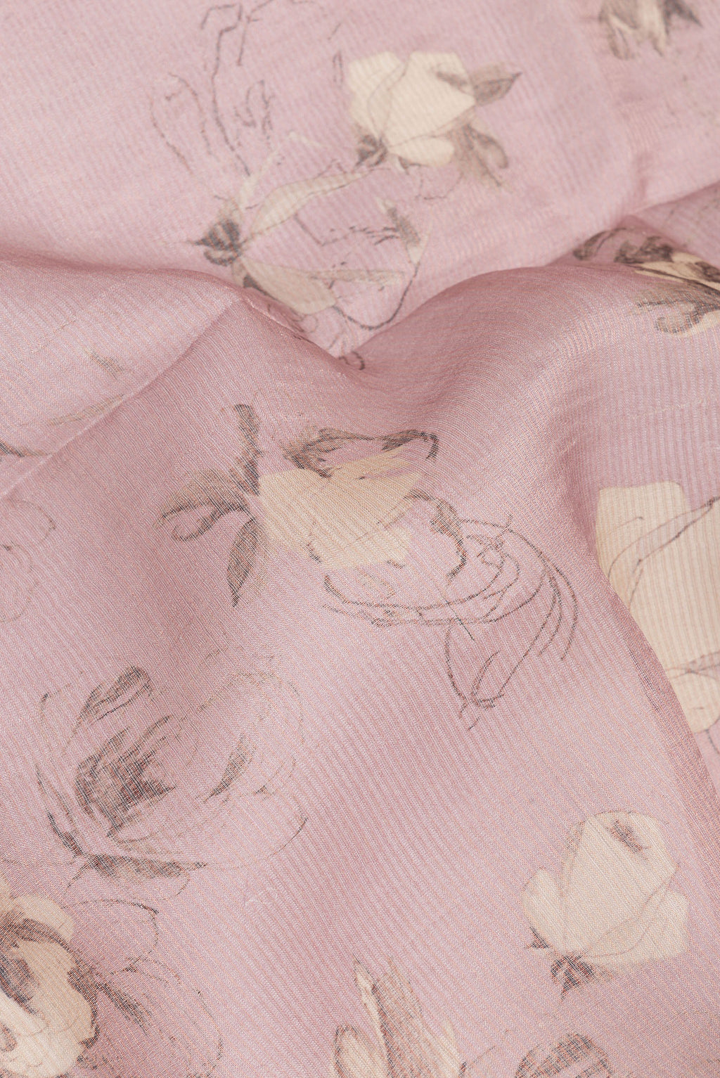 Close up of Rose Gold Tussar Saree with Floral Print on the body and Sequin Border.  displaying folds