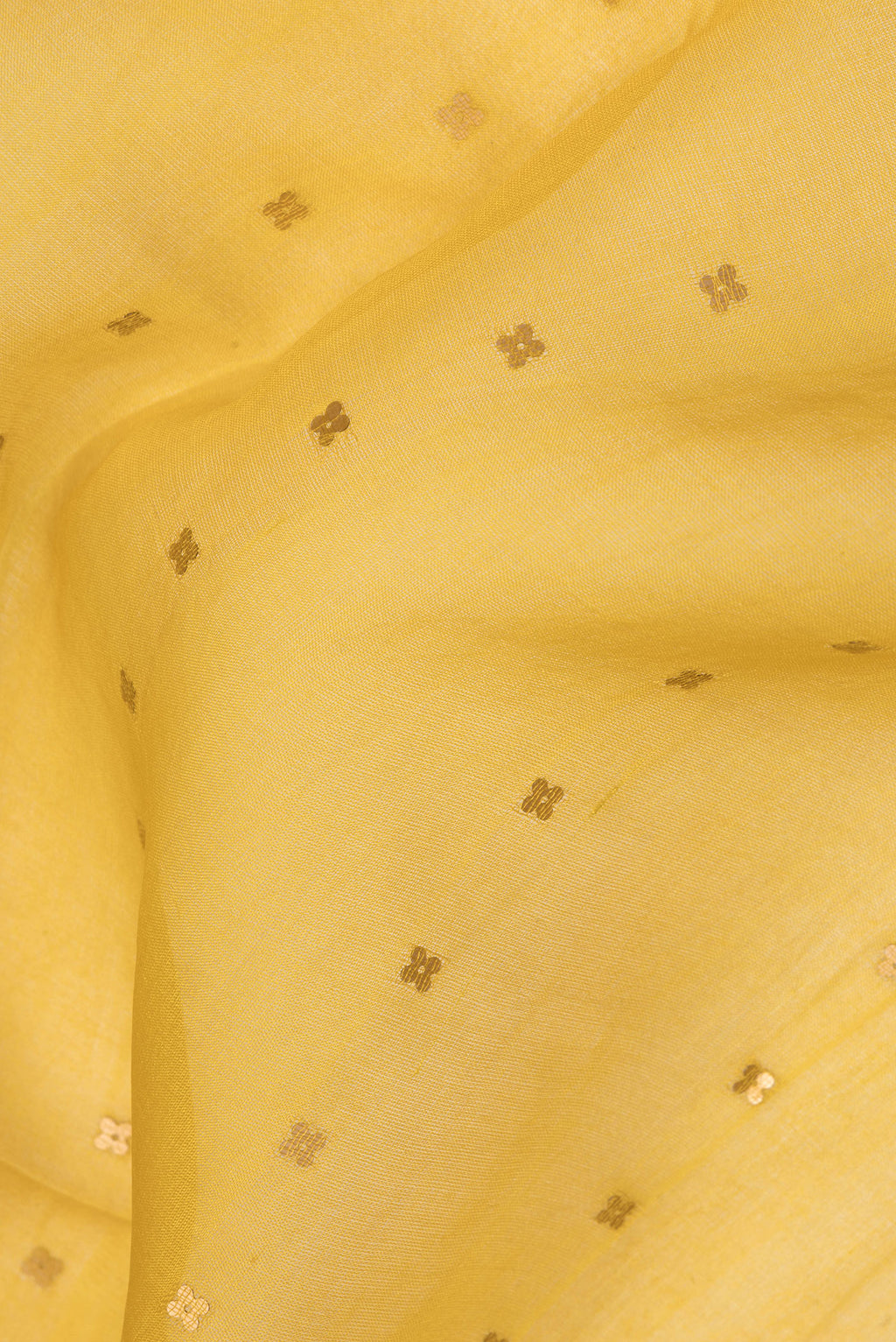 Close up of Yellow Tussar Saree with Embroidery on the body and Zari Border.  displaying folds