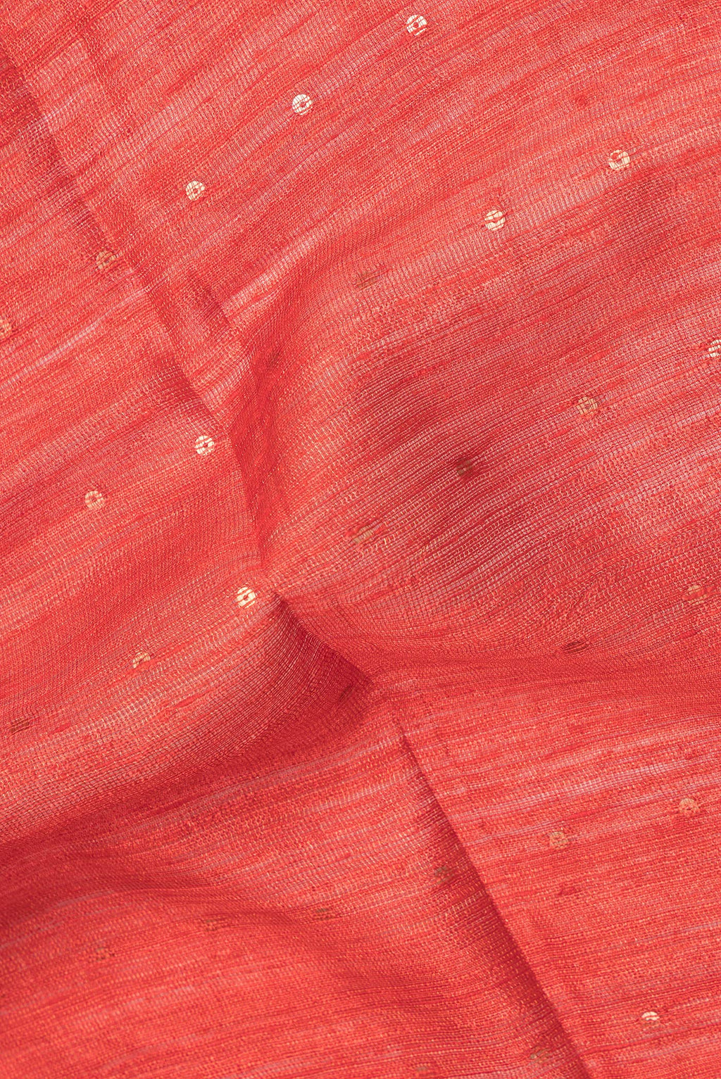 Close up of Pure Silk Orange Tussar Saree with Embroidery on the body and Zari Border.  displaying folds