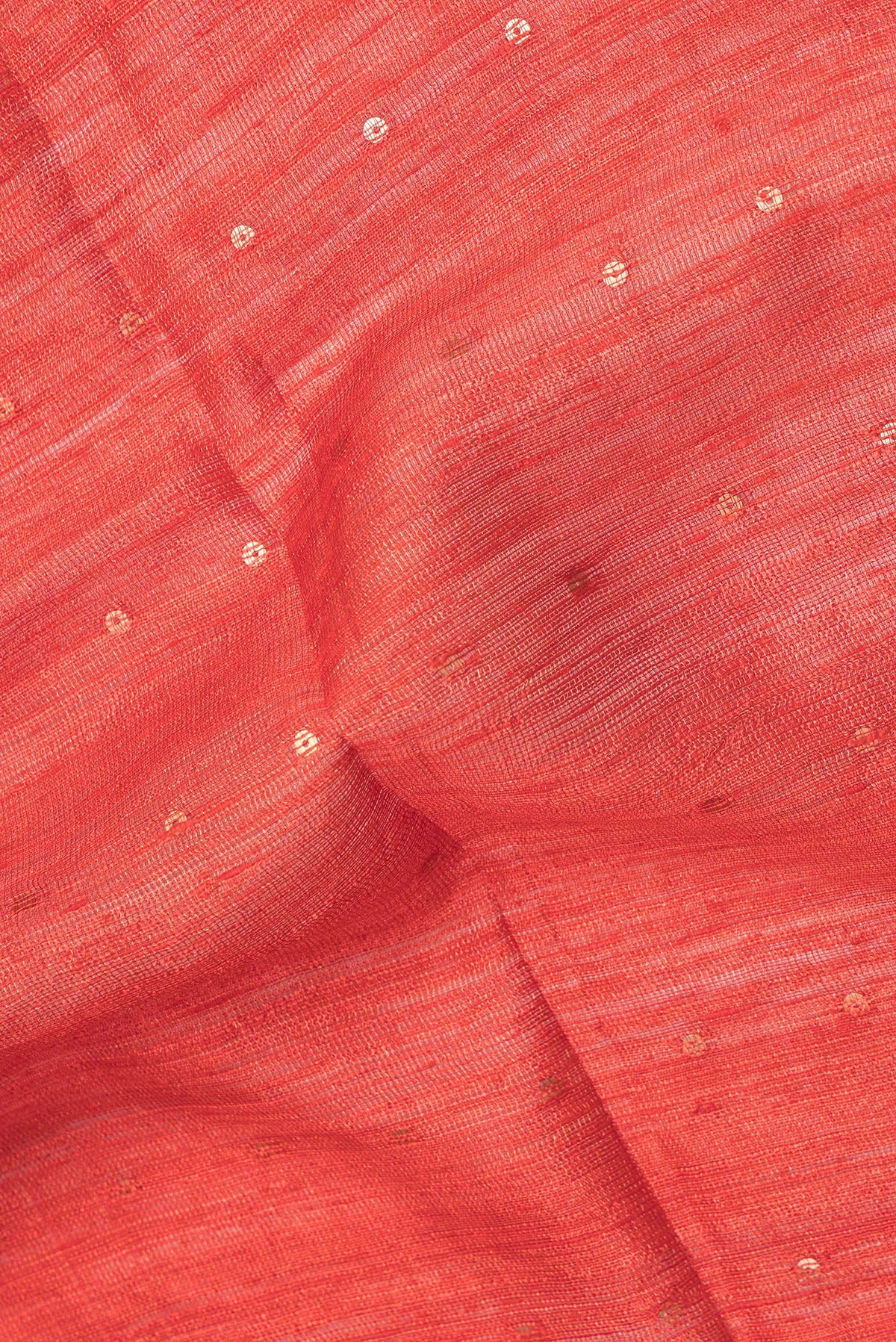 Close up of Pure Silk Orange Tussar Saree with Embroidery on the body and Zari Border.  displaying folds
