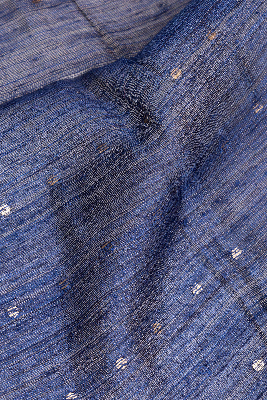 Close up of Pure Silk Dark Blue Tussar Saree with Embroidery on the body and Zari Border.  displaying folds